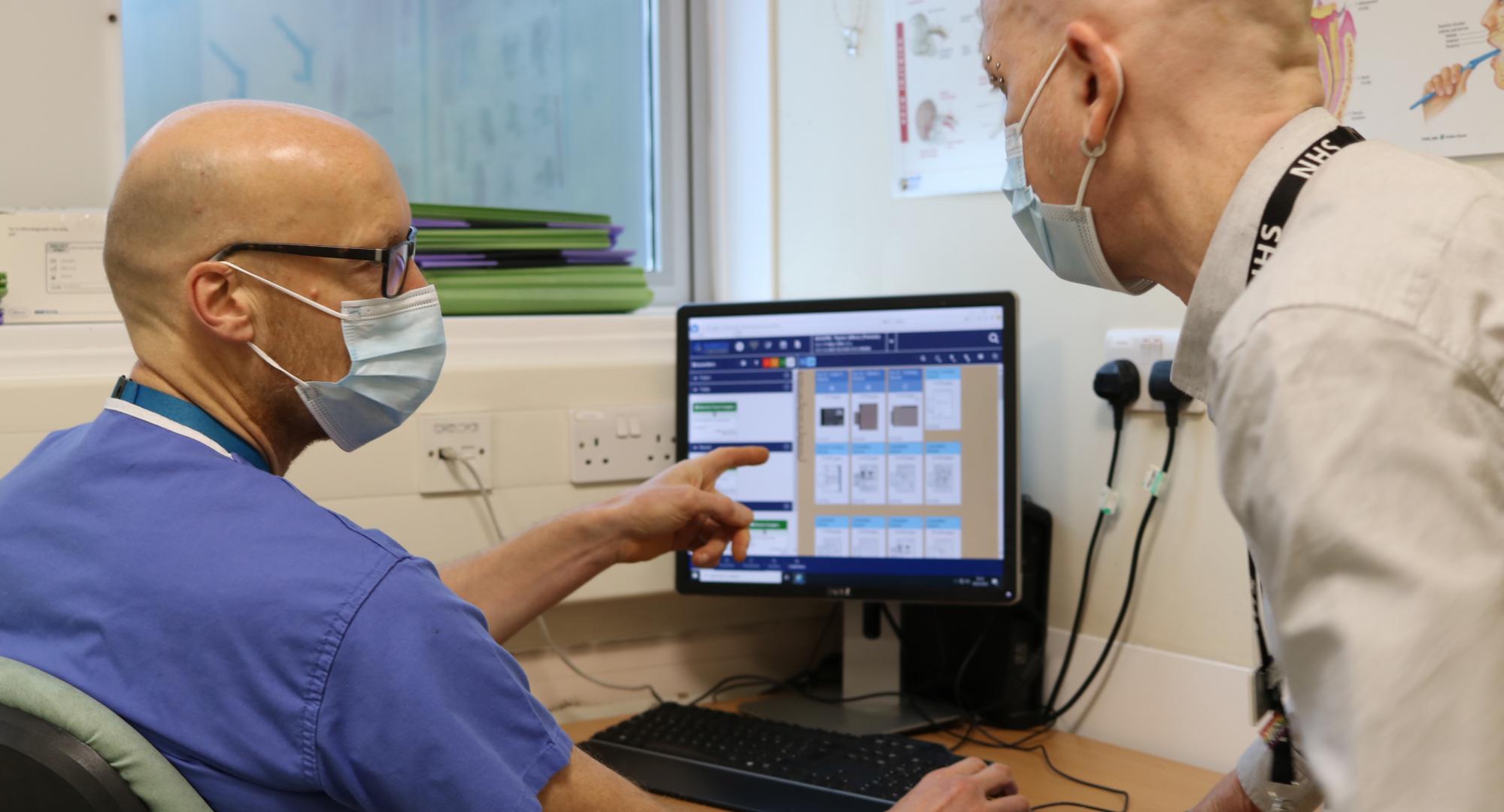 nhs staff looking at computer screen