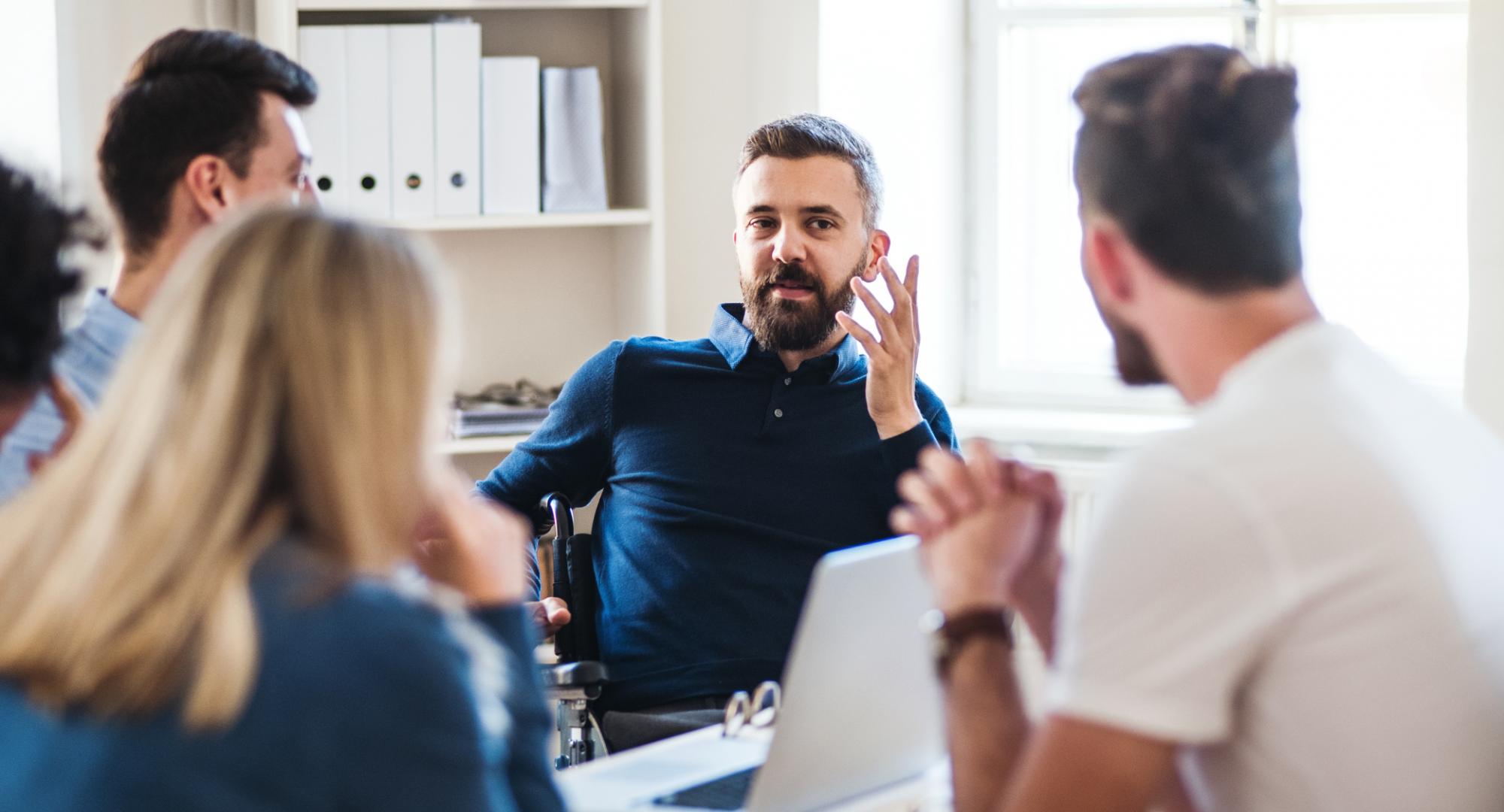 Man discussing in a meeting with colleagues