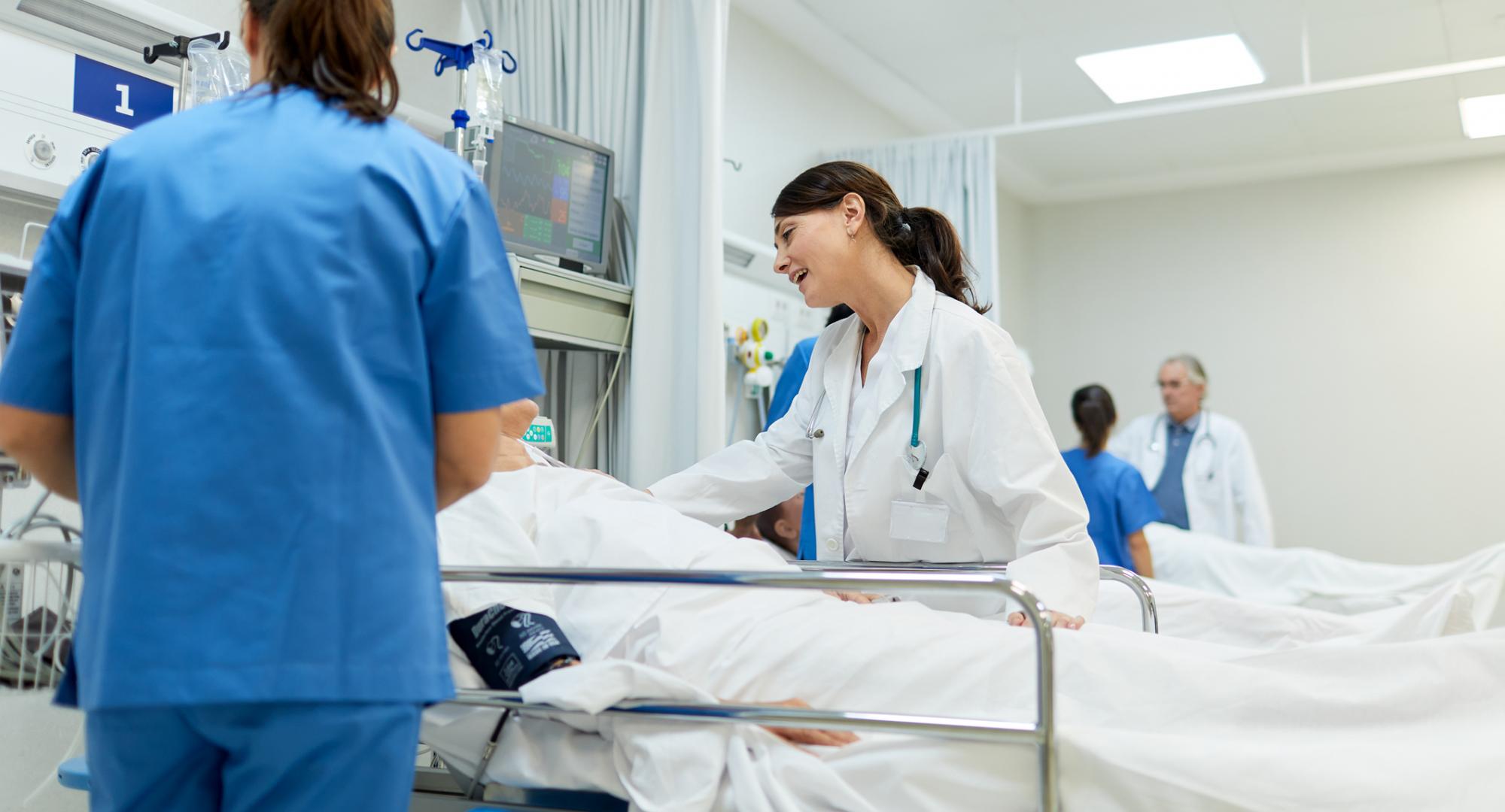 Doctor speaking to a patient in a hospital bed