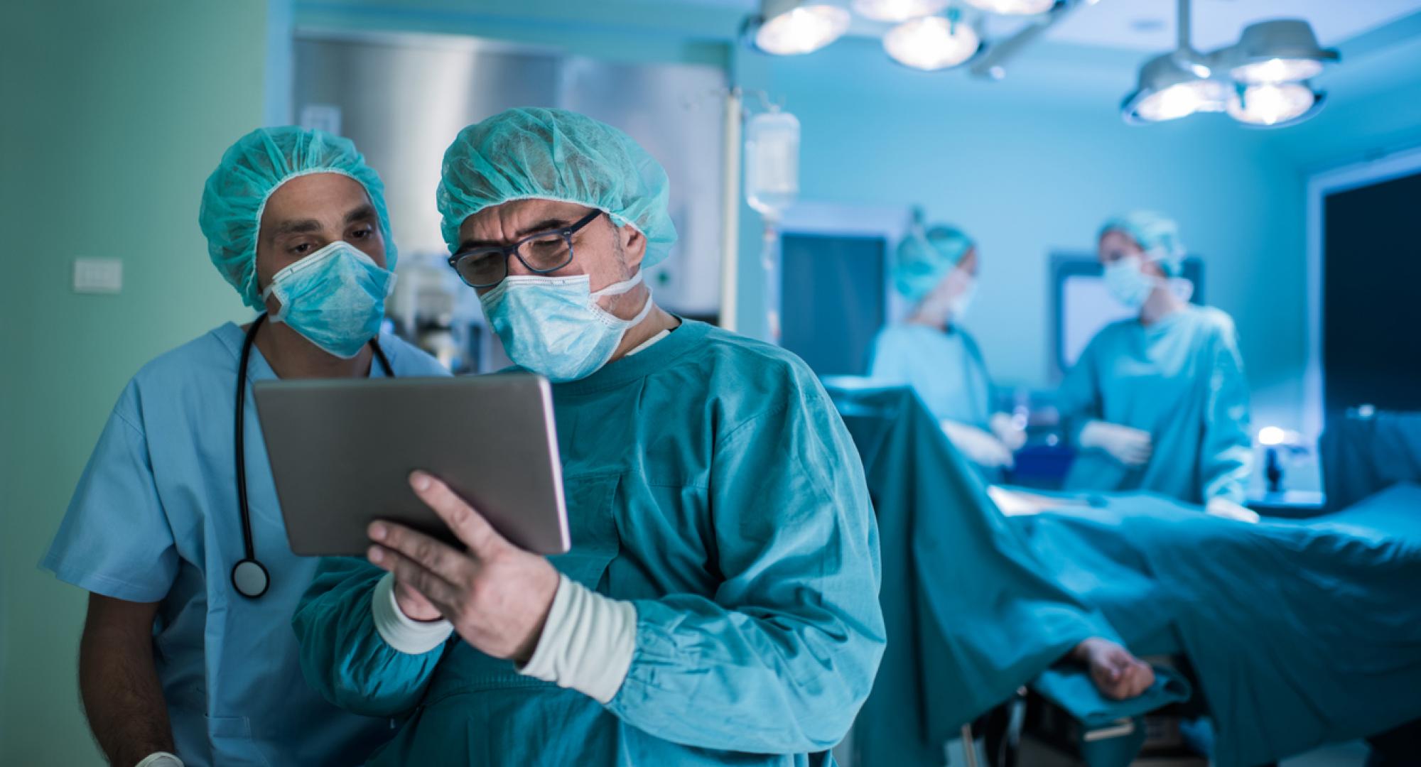 two surgeons using tablet in theatre 