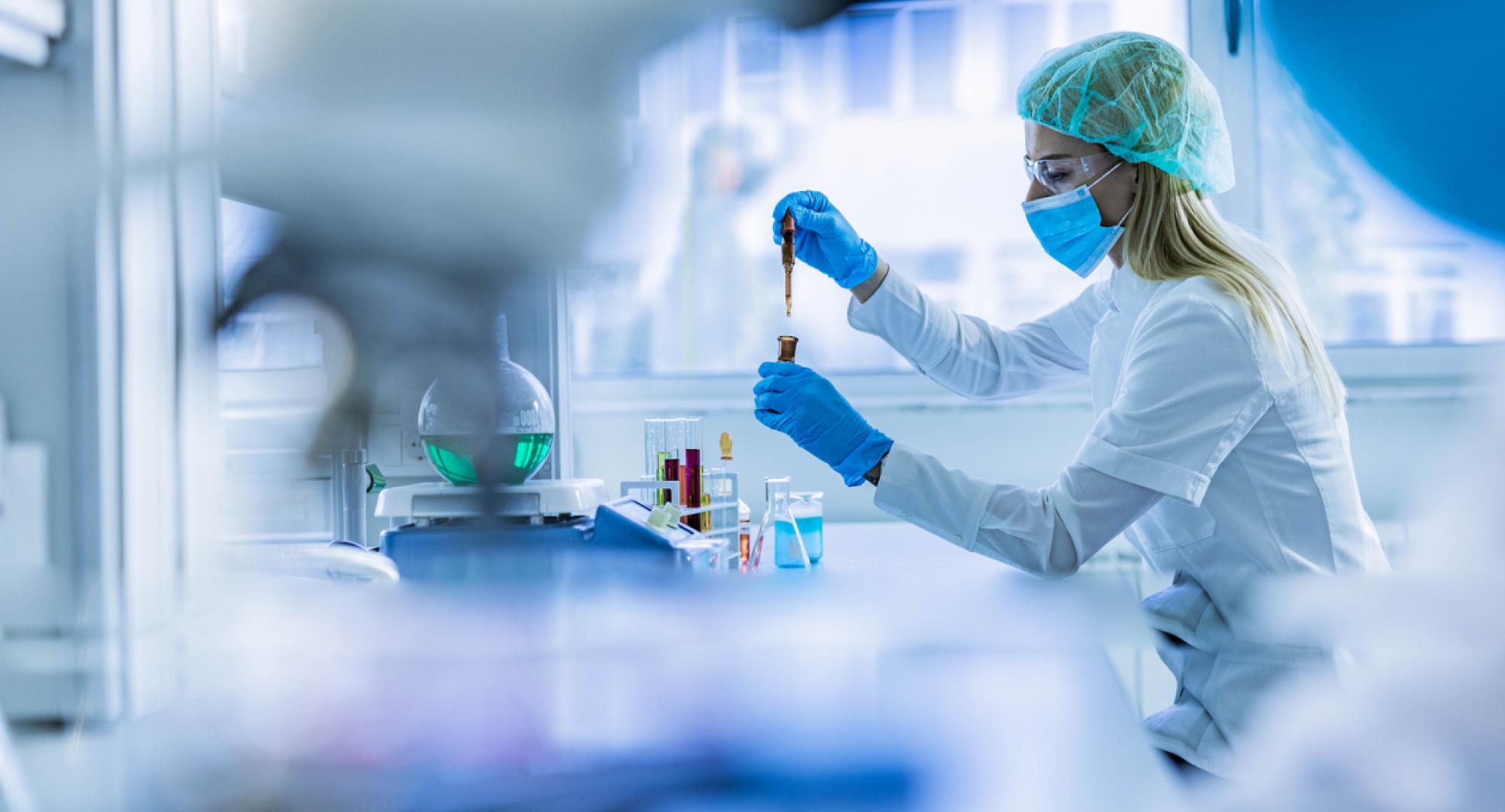 Female scientist examining toxic liquid in laboratory