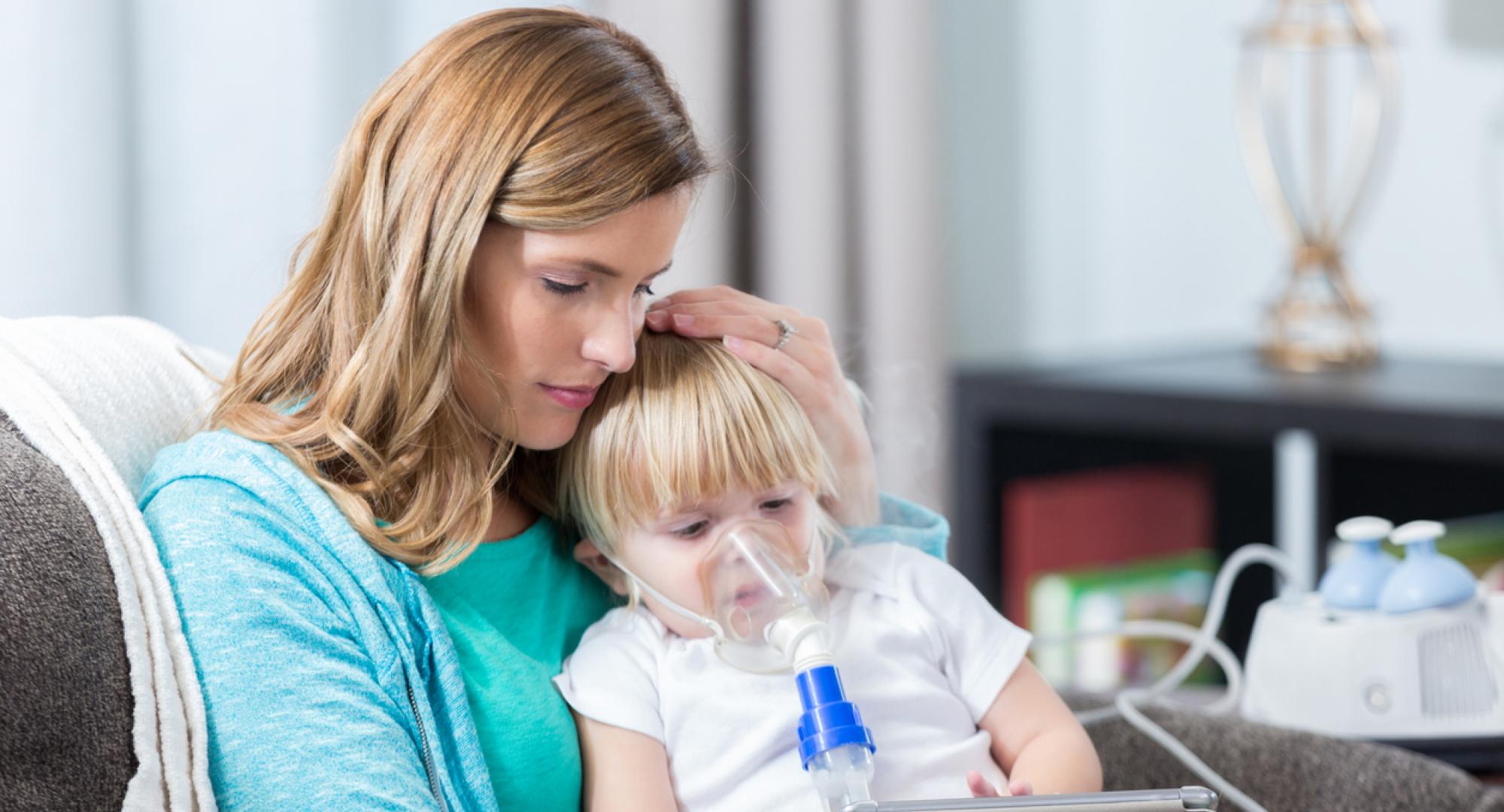 Young girl with cystic fibrosis receives breathing treatment