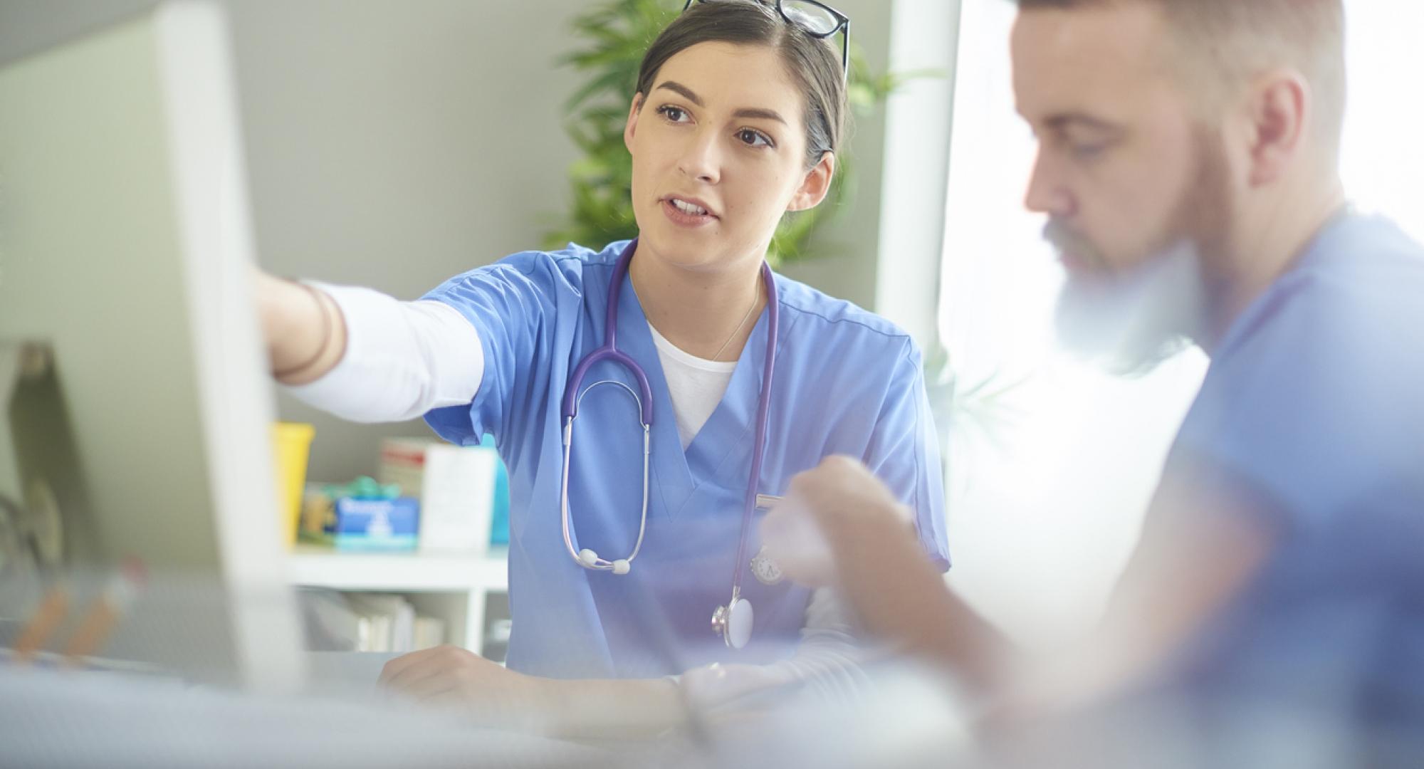 Medical professionals discussing notes