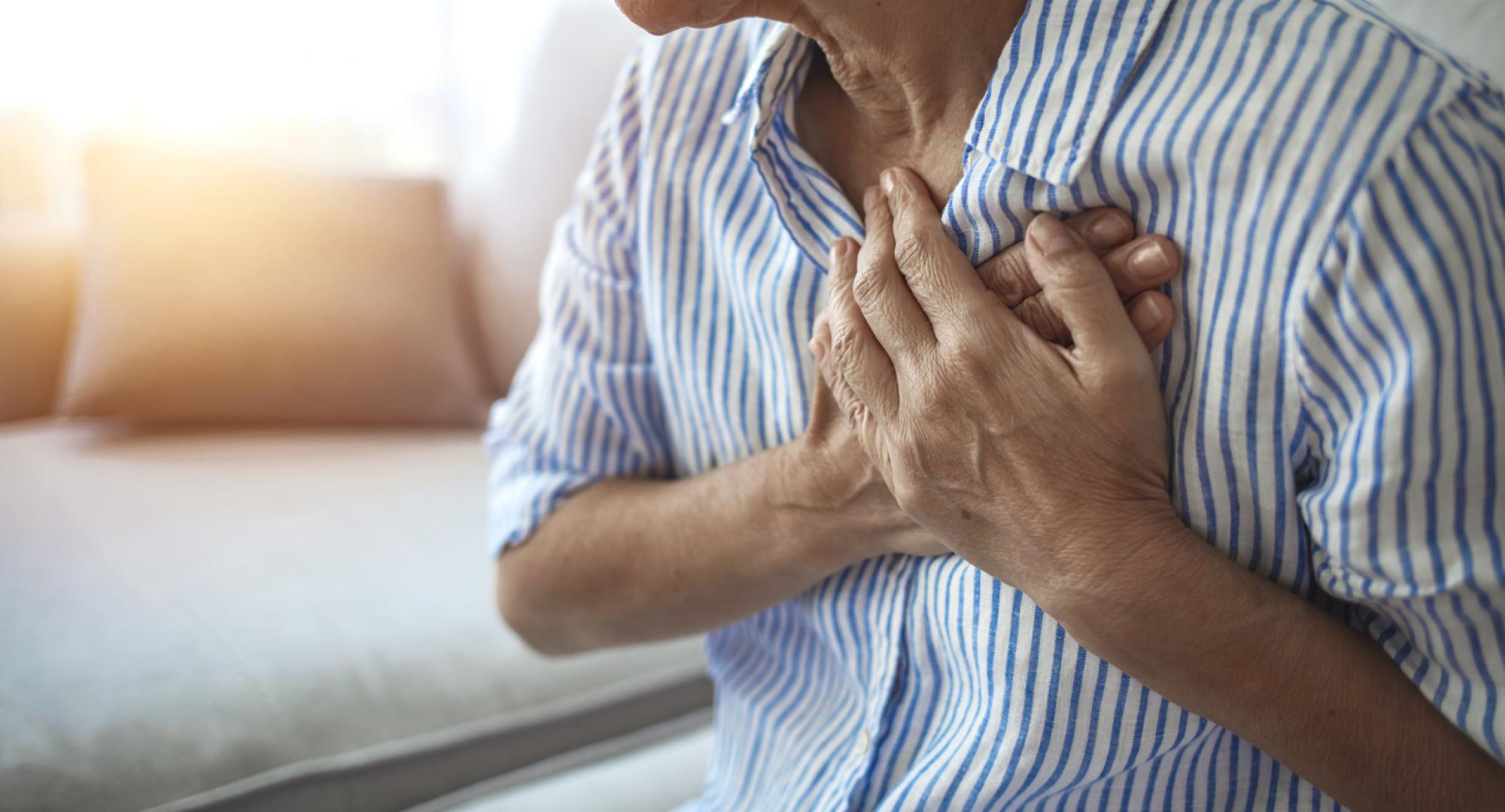 Man holding chest with heart condition