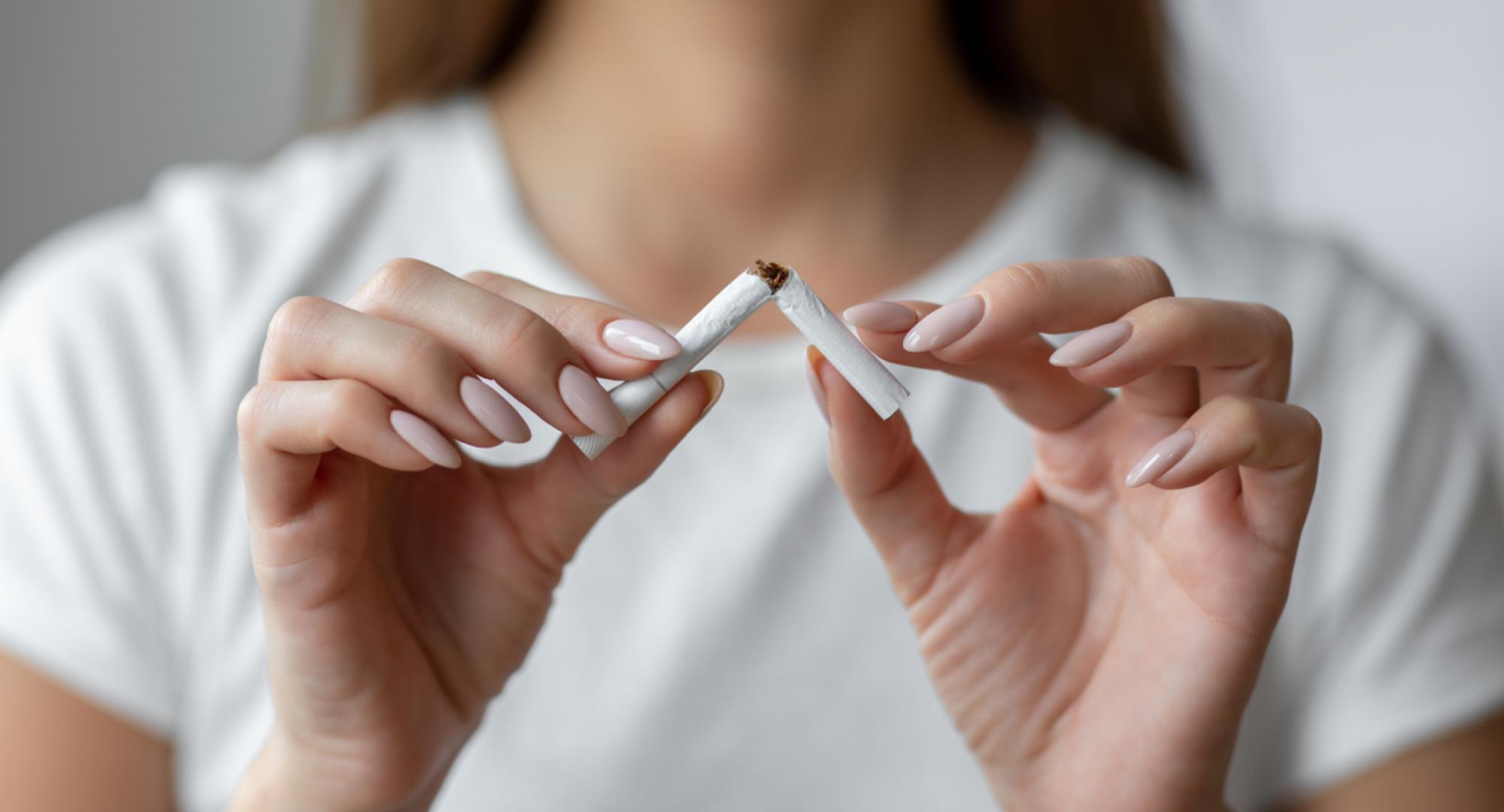 Woman breaking a cigarette in half