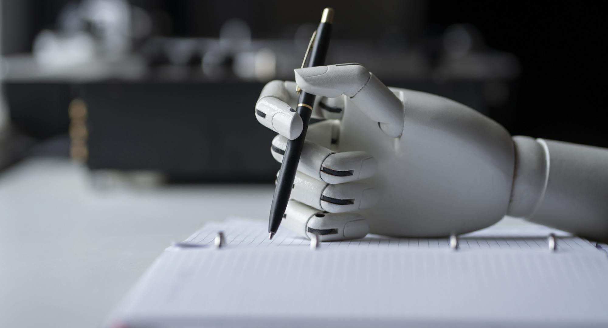 Robot holding a pen depicting AI tools in healthcare peer-reviewing grant applications