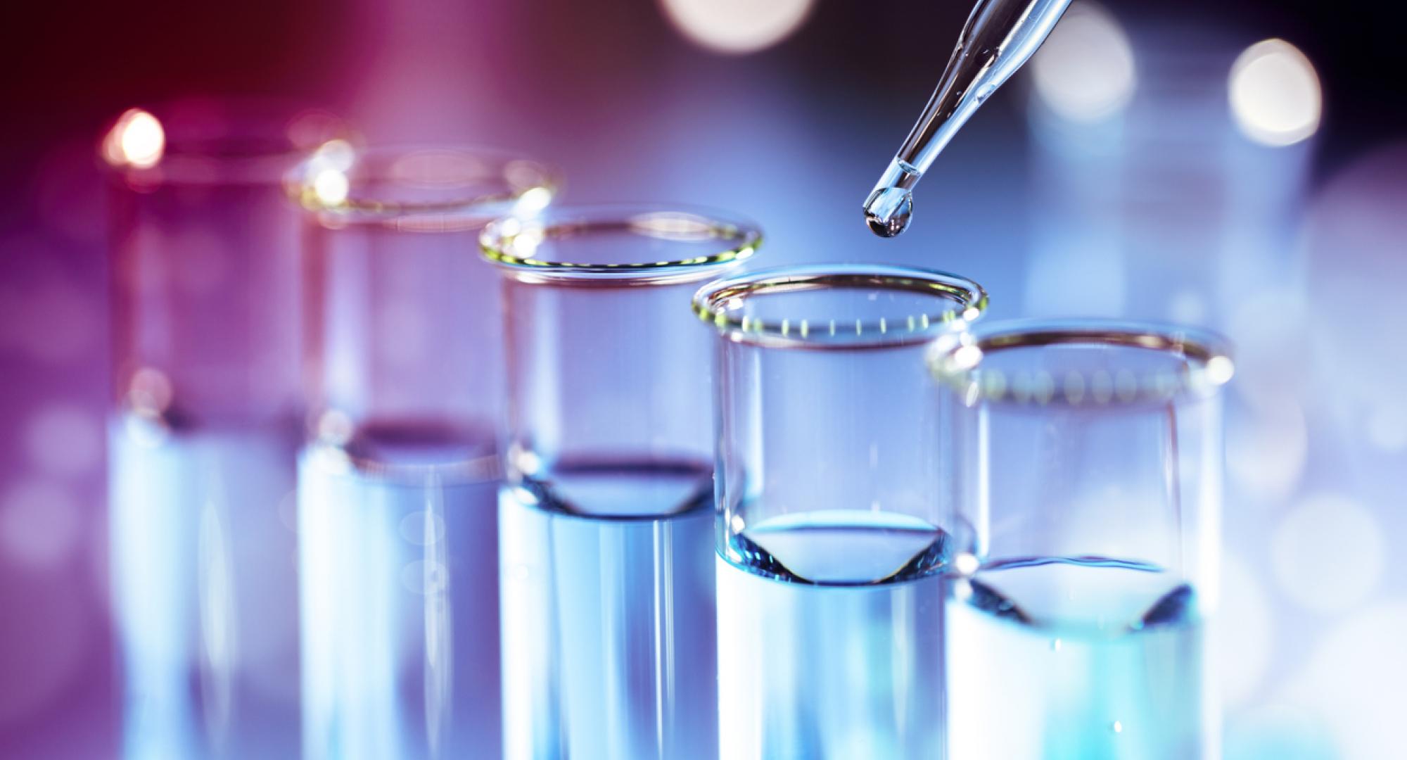 Science beakers in a line depicting cancer research