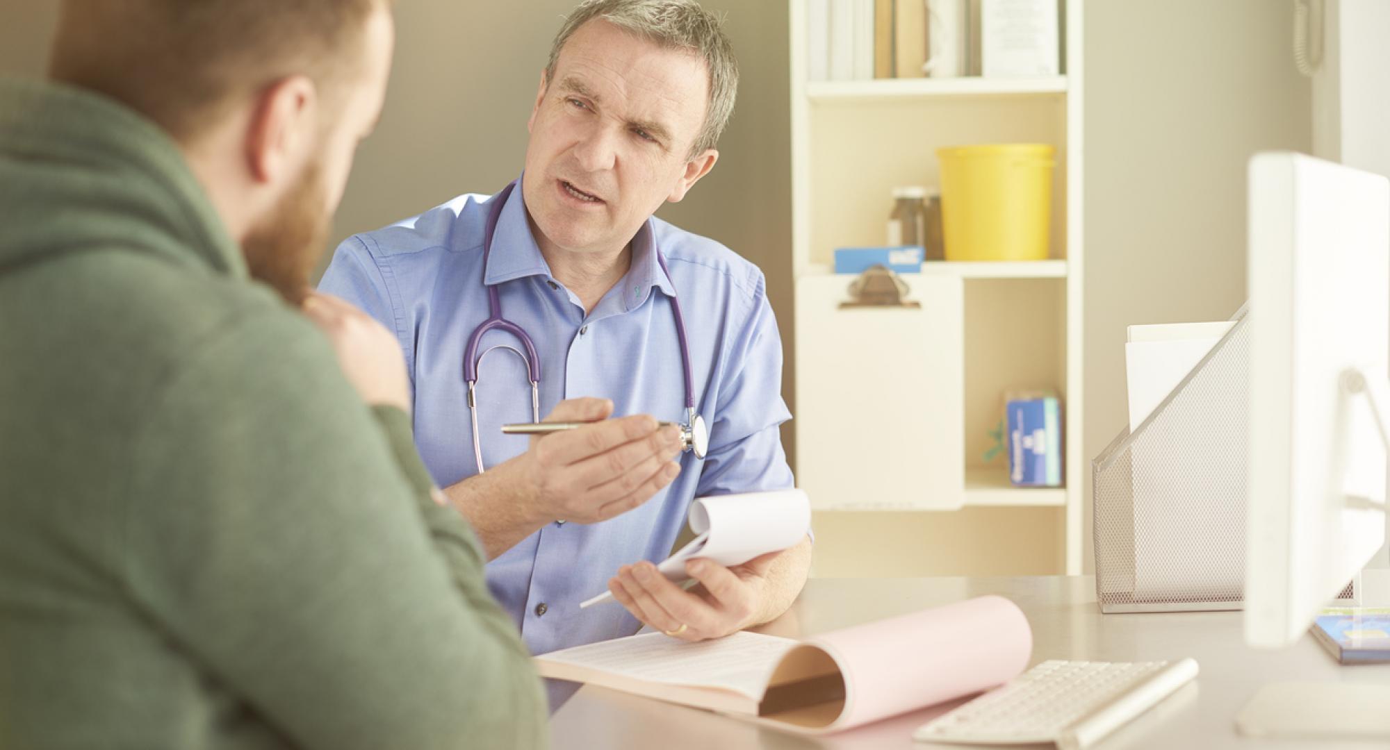 Doctor consulting man about patient safety