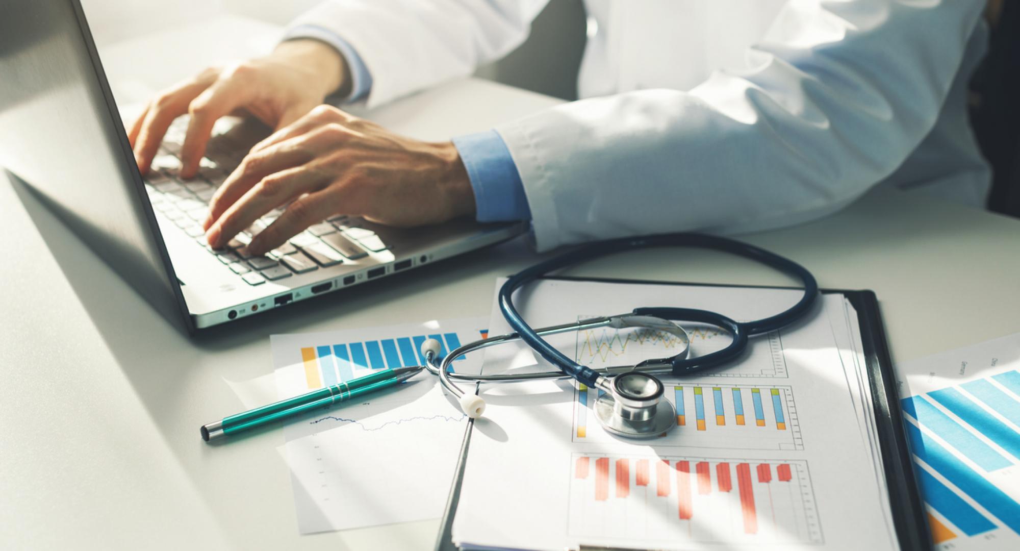 Doctor working with paperwork depicting the new equality, diversity and inclusion figures from the new workplace disability standard data