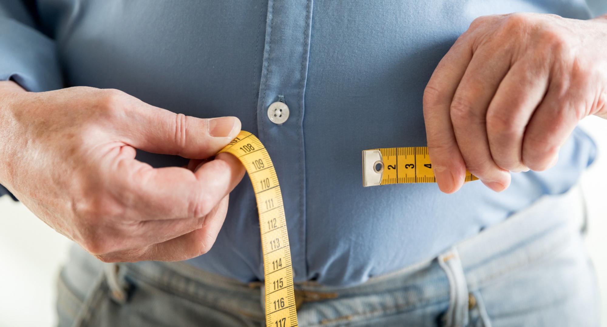 Person measuring their waist depicting type 2 diabetes treatment