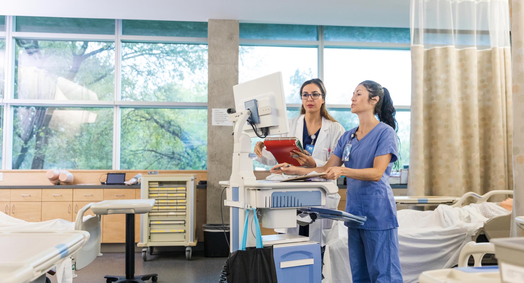 Doctors using a computer to access patient data