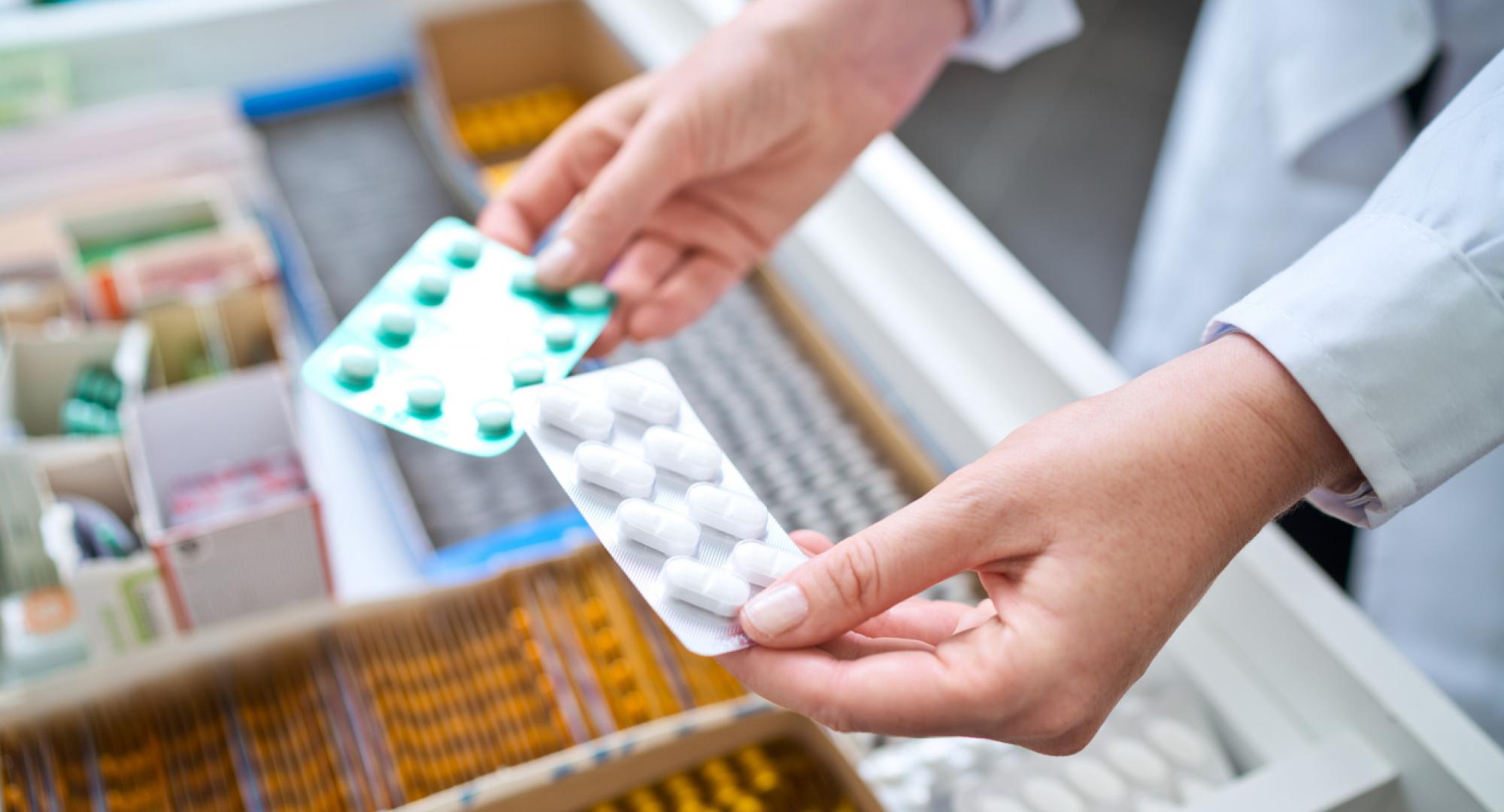 Female pharmacist holding medicines