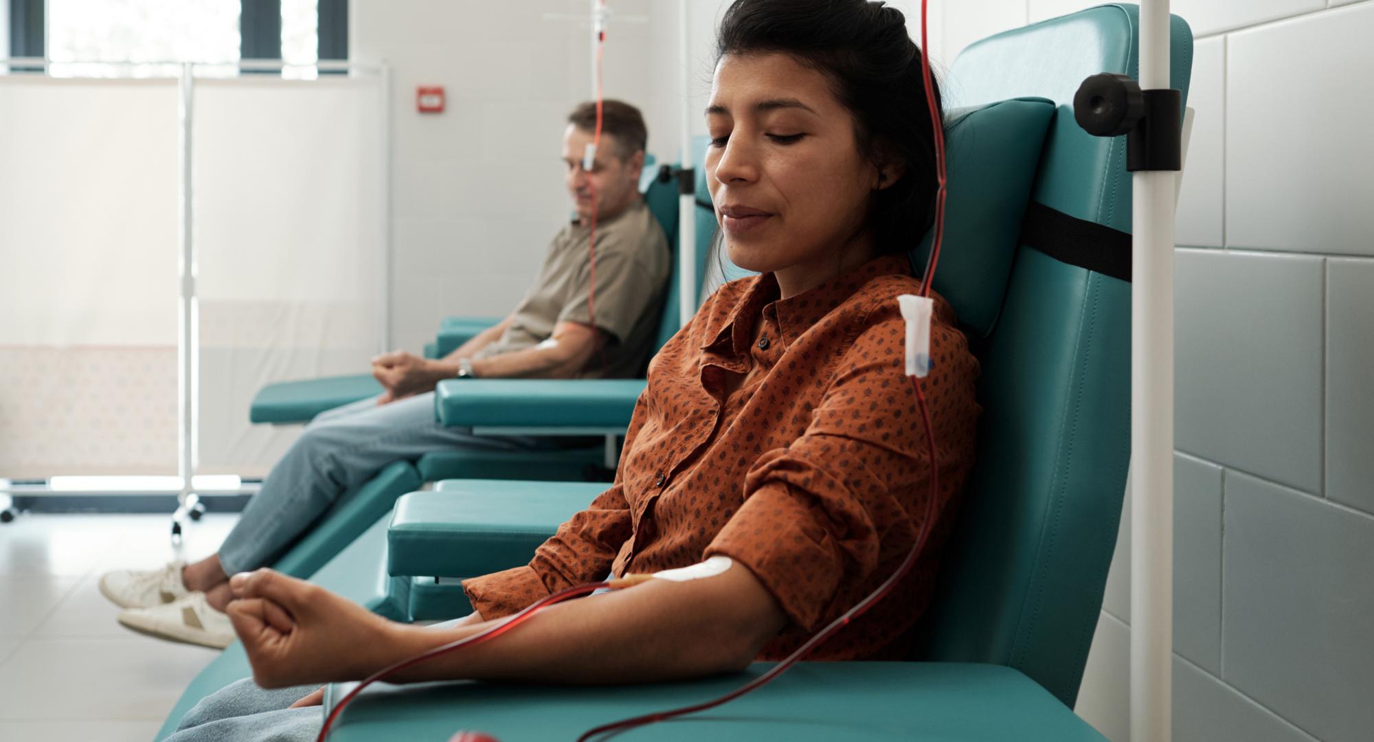 Young woman and mature man giving blood for sick patients