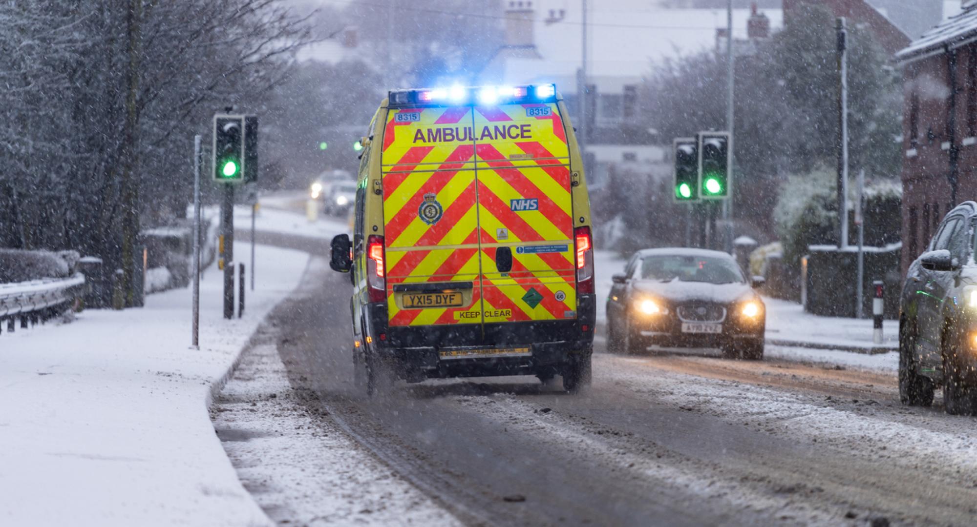 Ambulance in the snow depicting NHS winter pressures