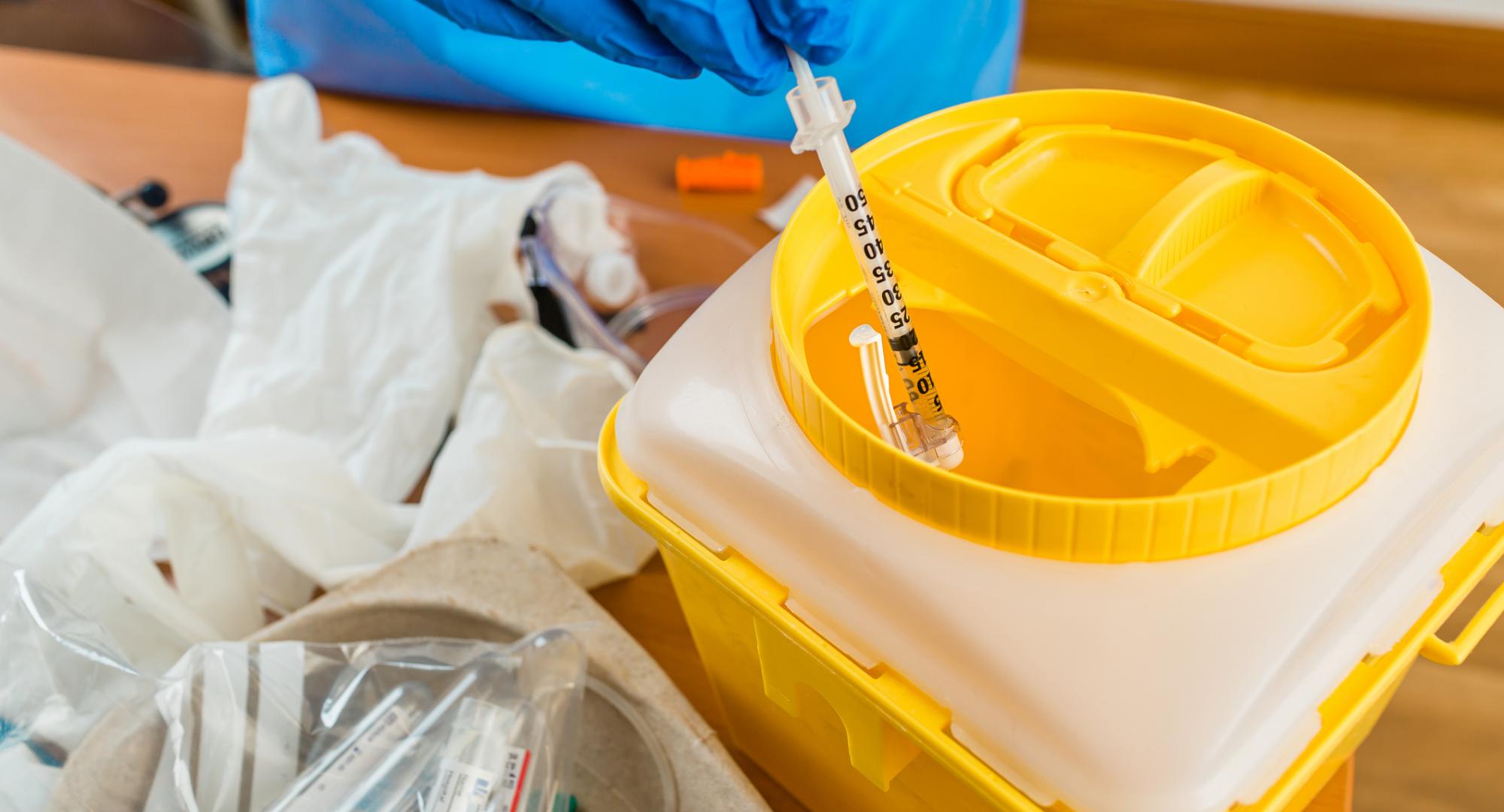 Needle being thrown into a container