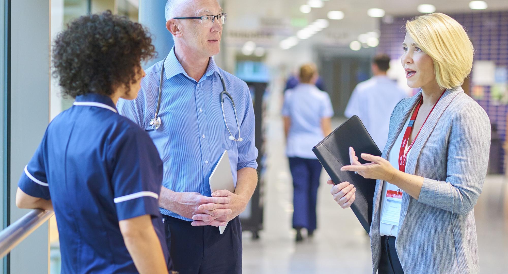 NHS professionals talking in a corridor