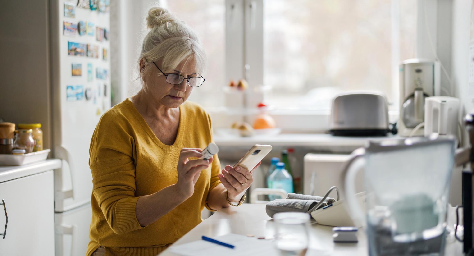Older woman on medication with mobile phone