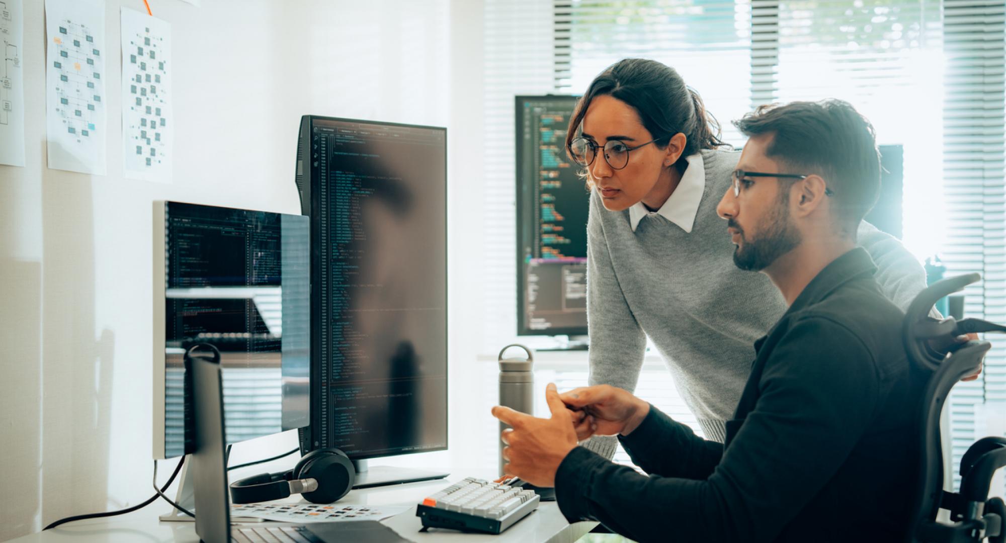 Two people looking at AI research