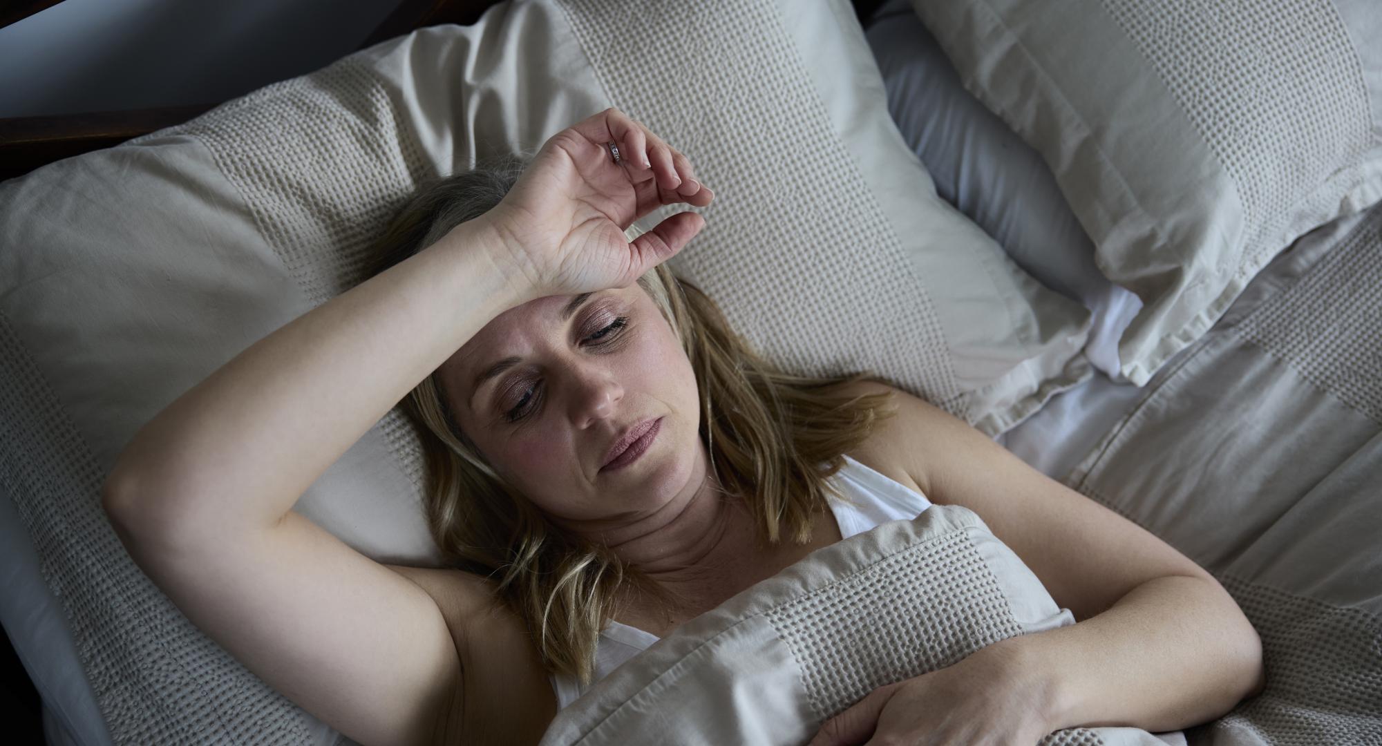 Woman in pain in bed