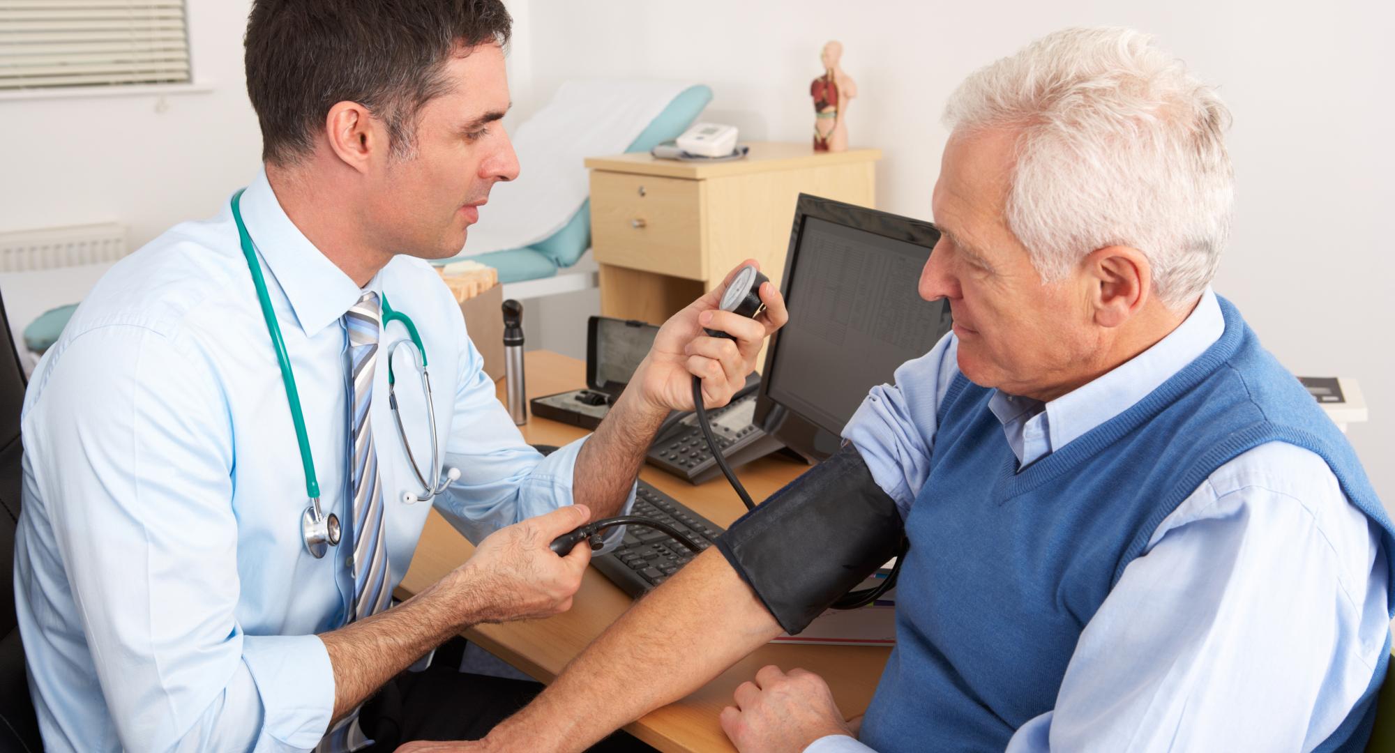 Doctor taking a man's blood pressure