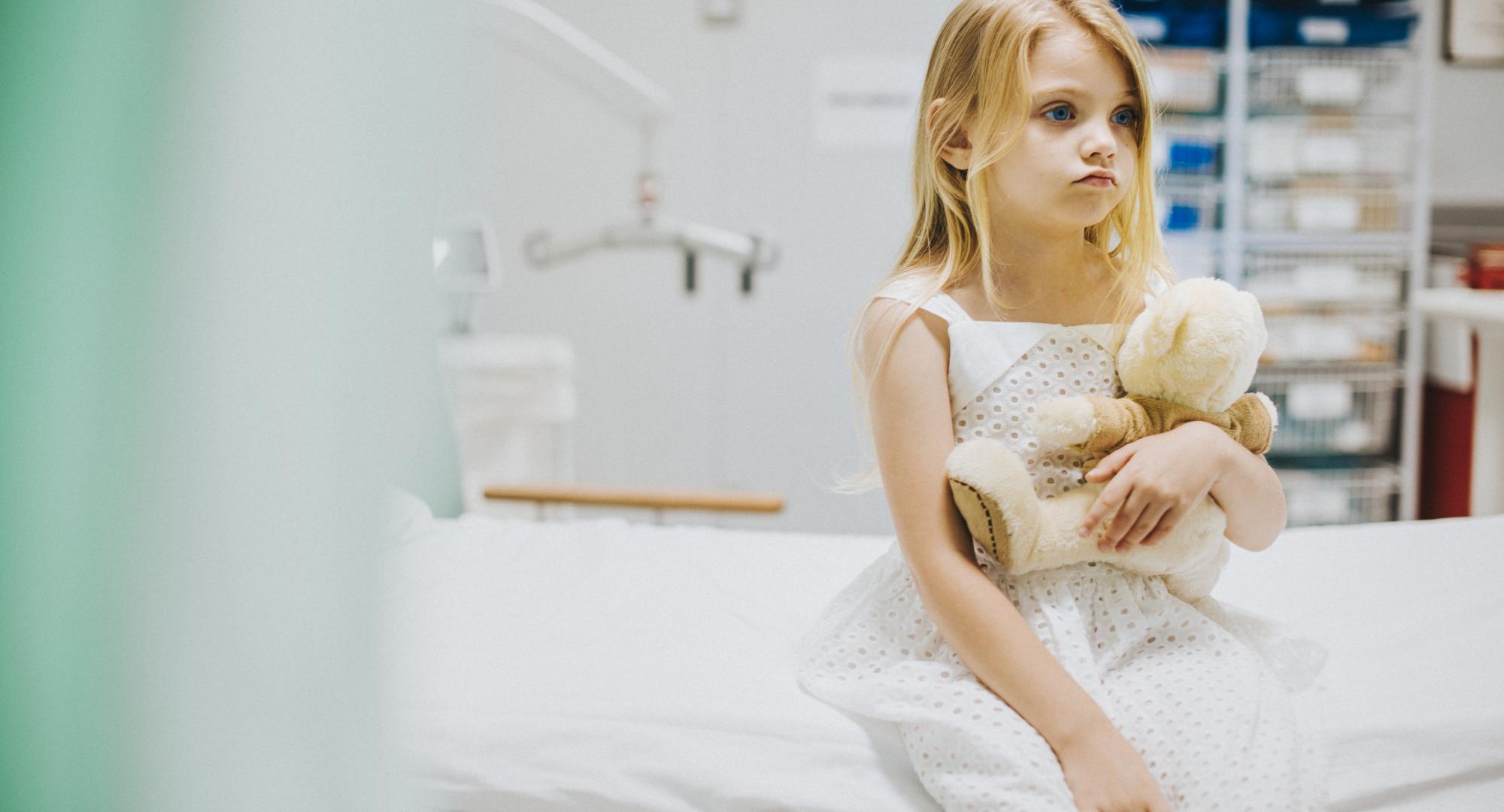 Child sitting on a hospital bed