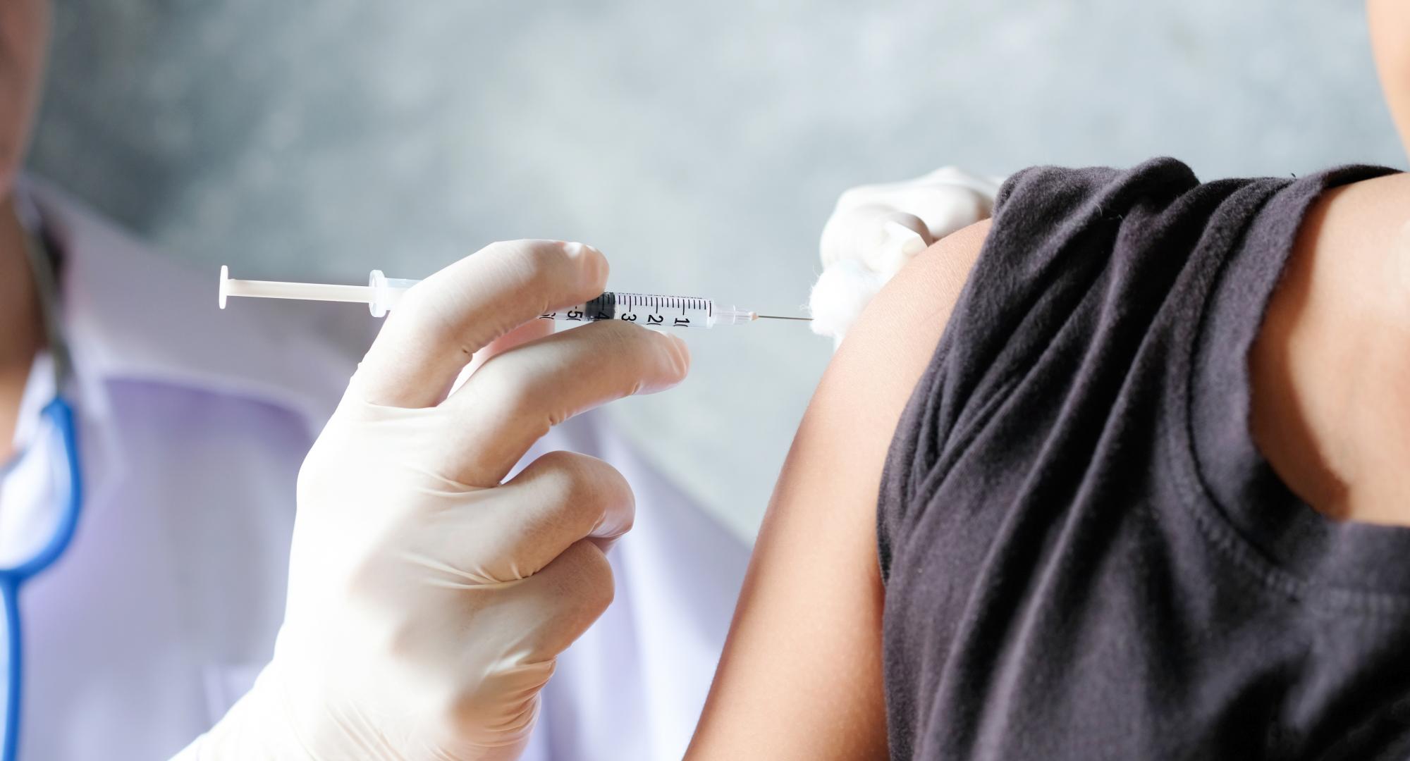Doctor injecting a patient with a vaccine