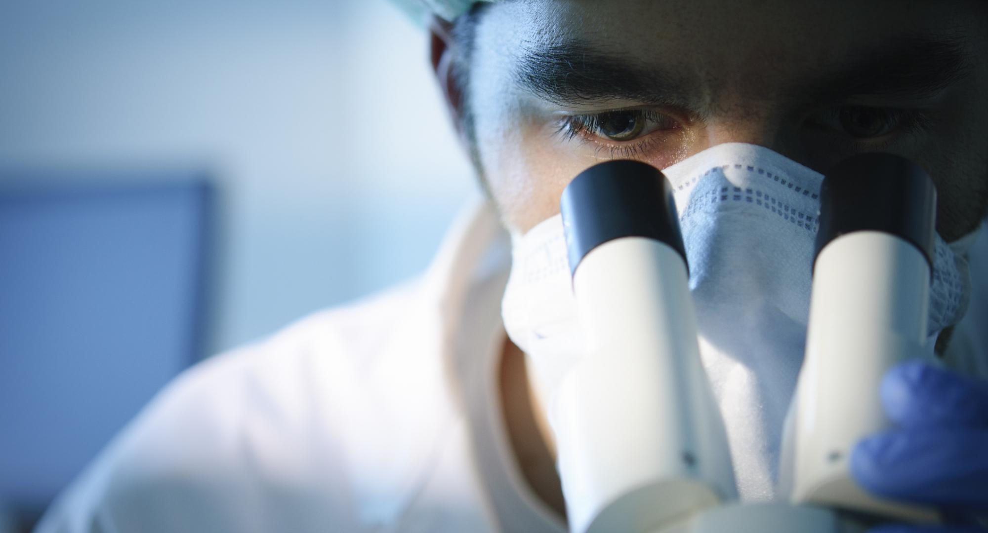 Scientist using a microscope
