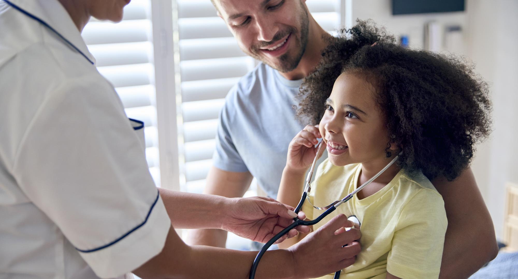 Young girl being treated by a nurse