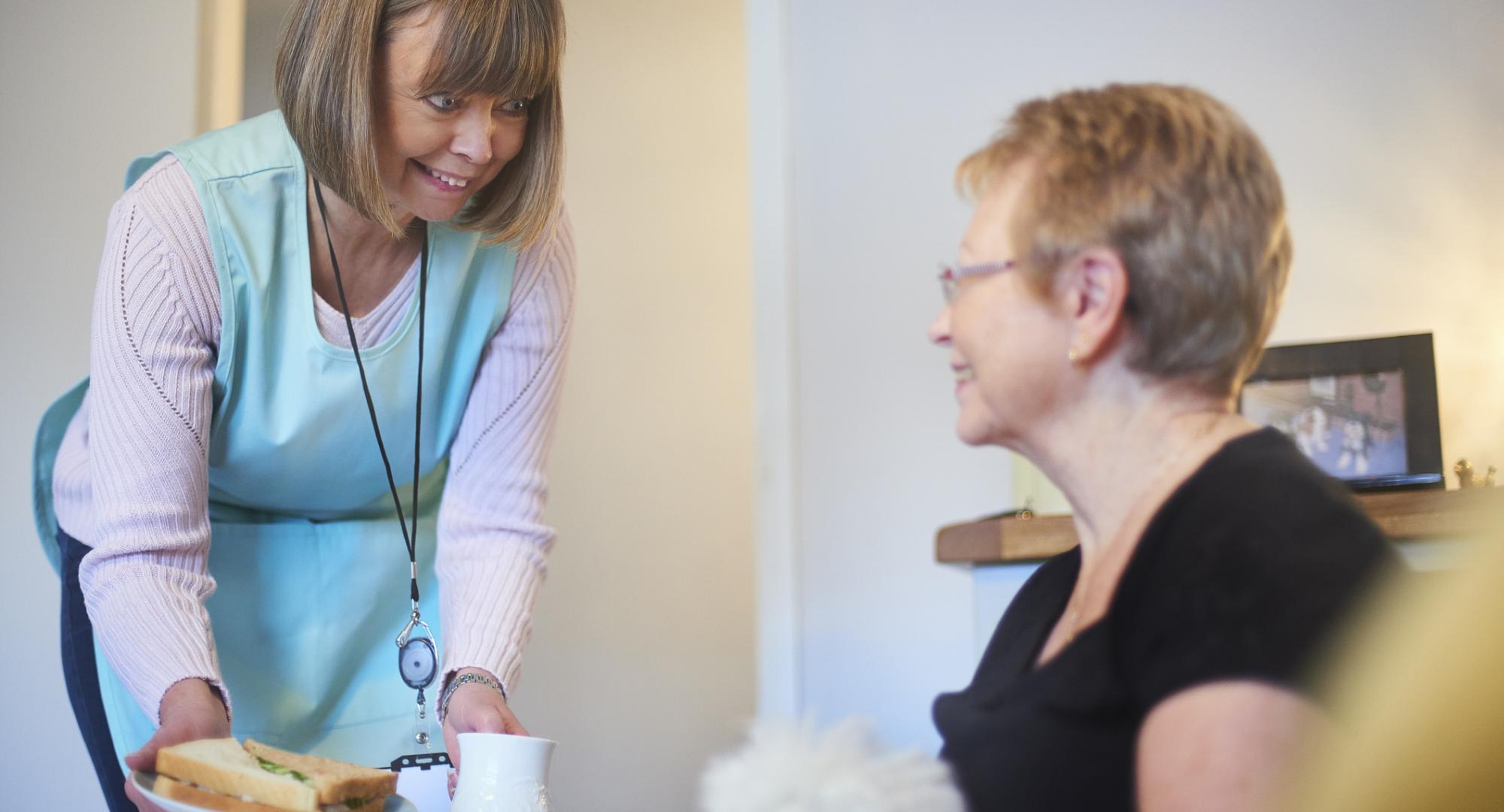Female NHS volunteer with a patient
