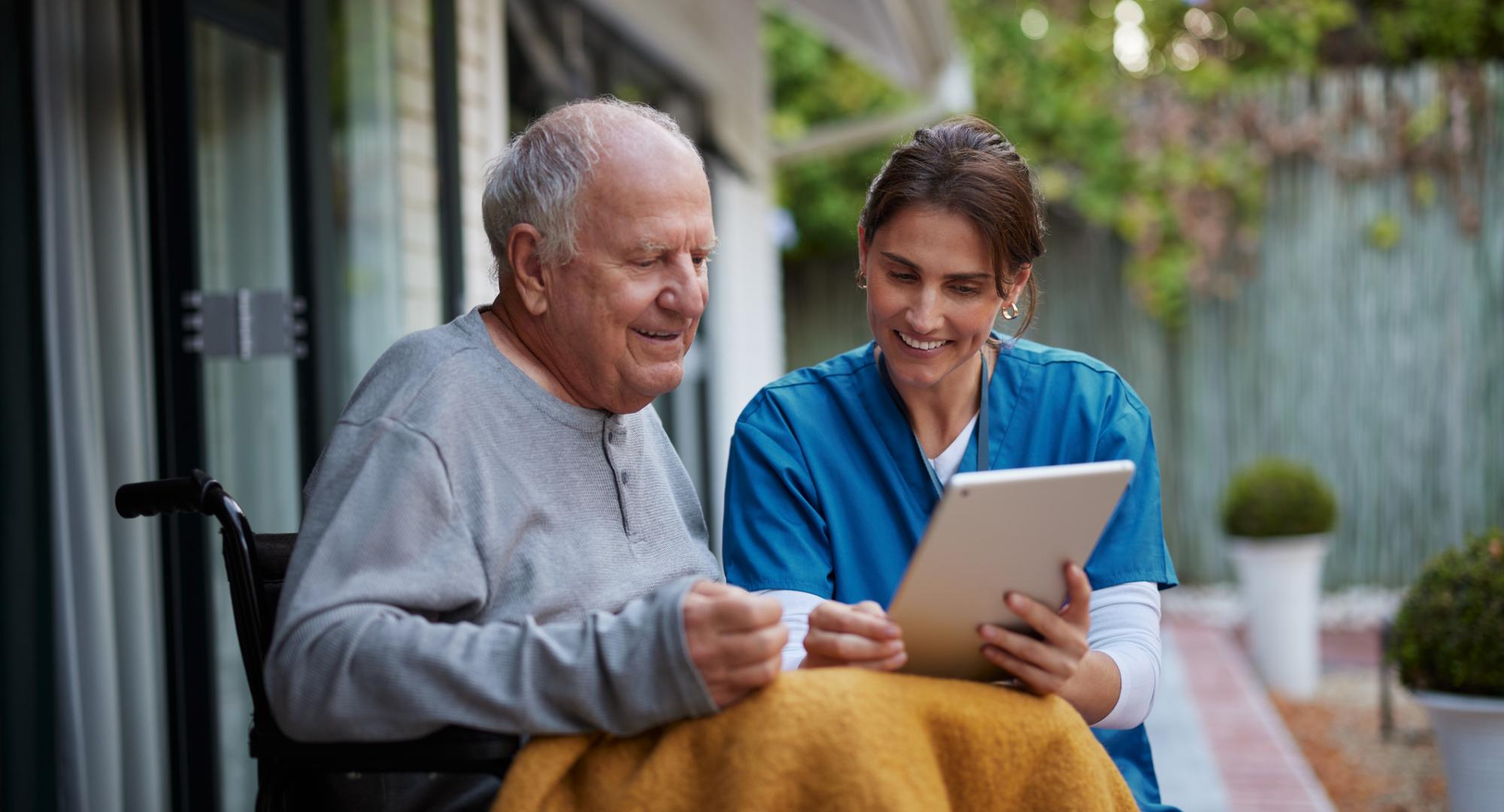 Nurse giving care at home to an elderly man