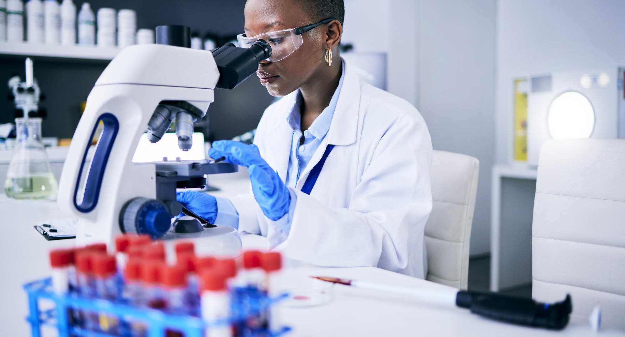 Scientist looking into a microscope