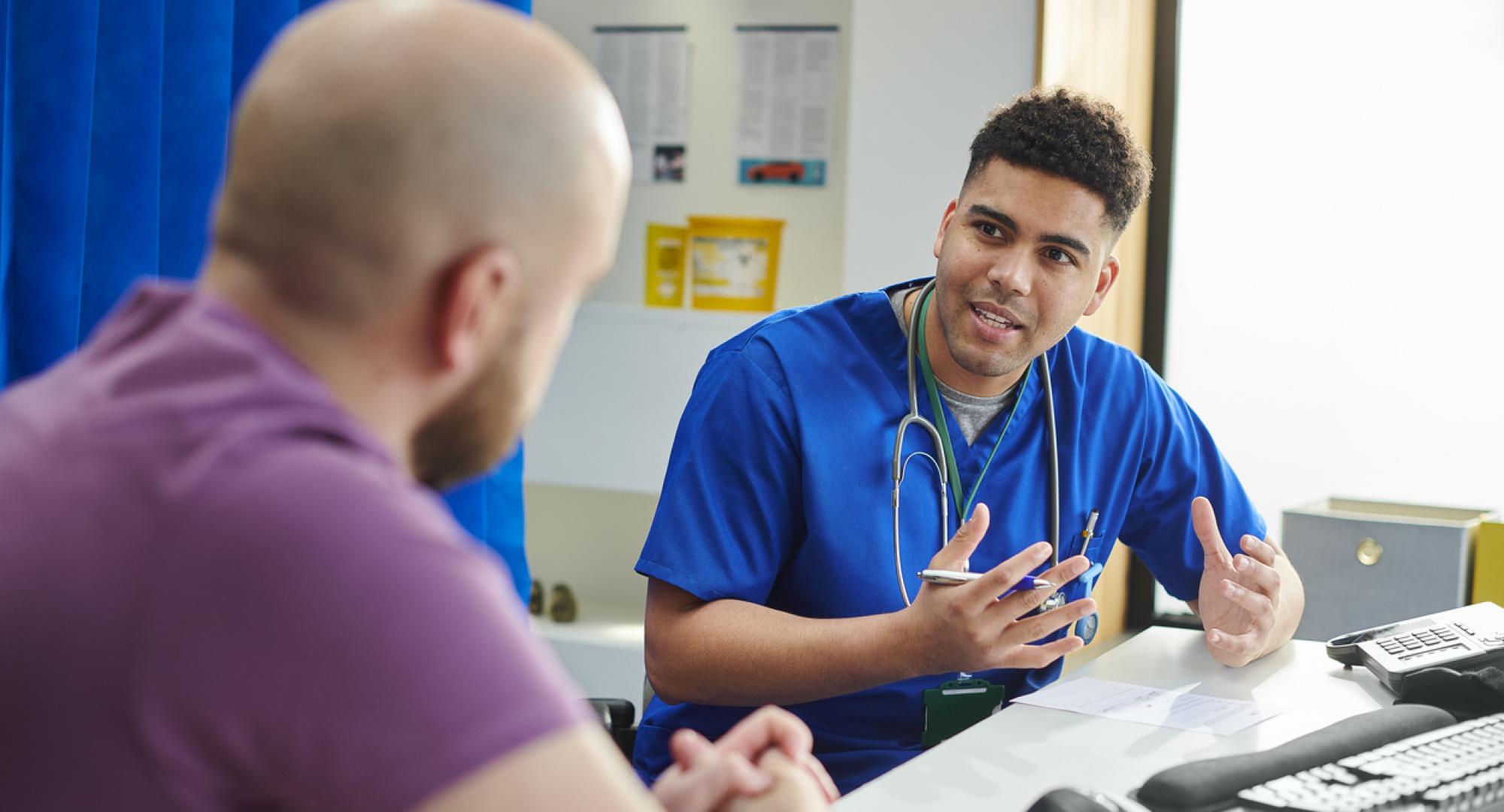 Doctor talking to male patient