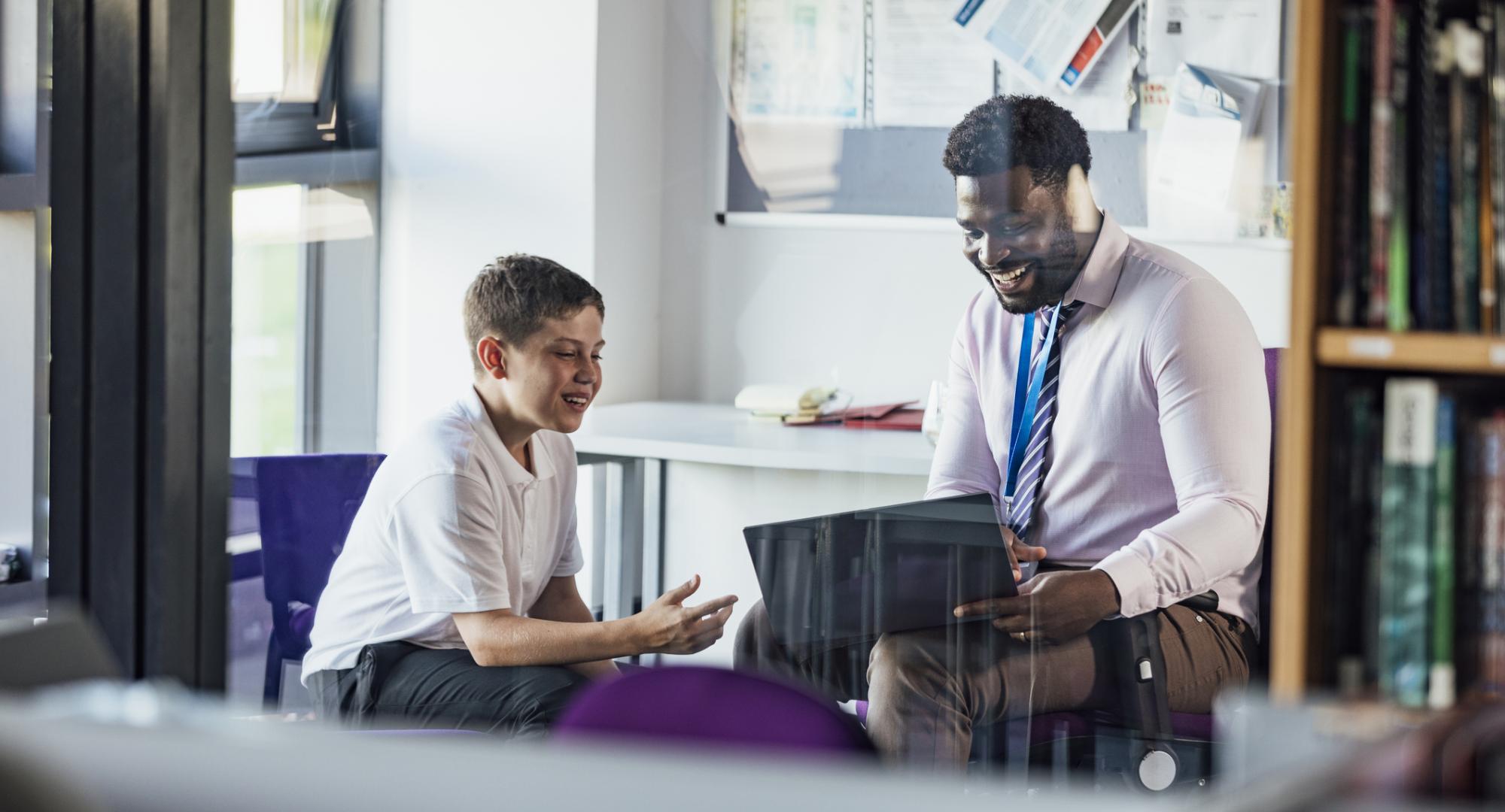 Teacher sat with a pupil