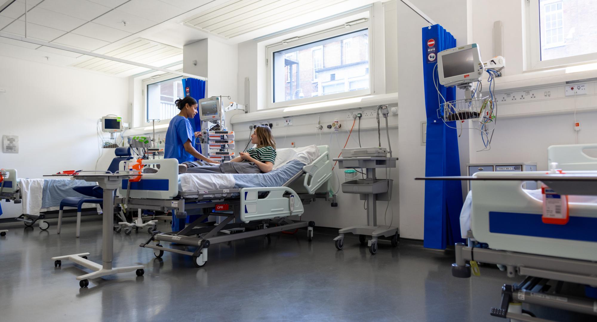 Woman in hospital talking to a nurse