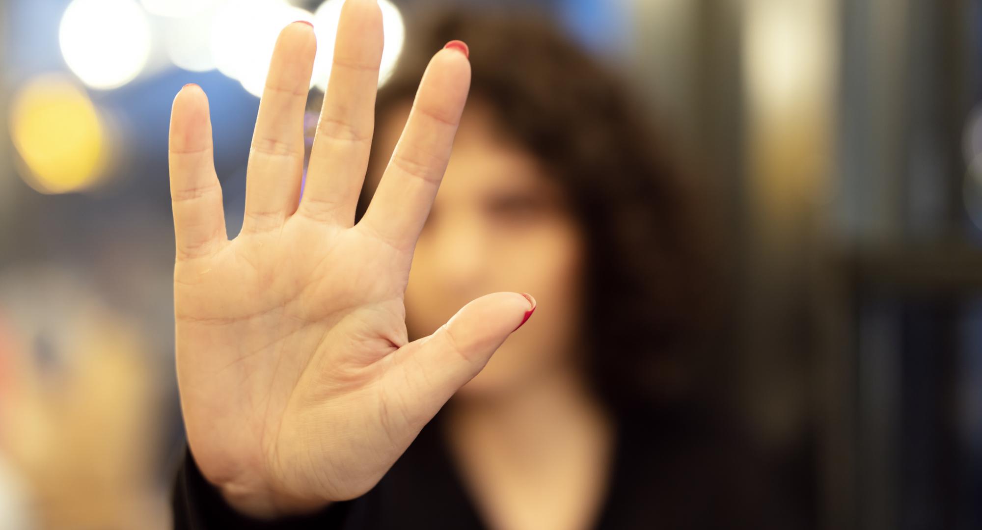 Woman holding her hand up