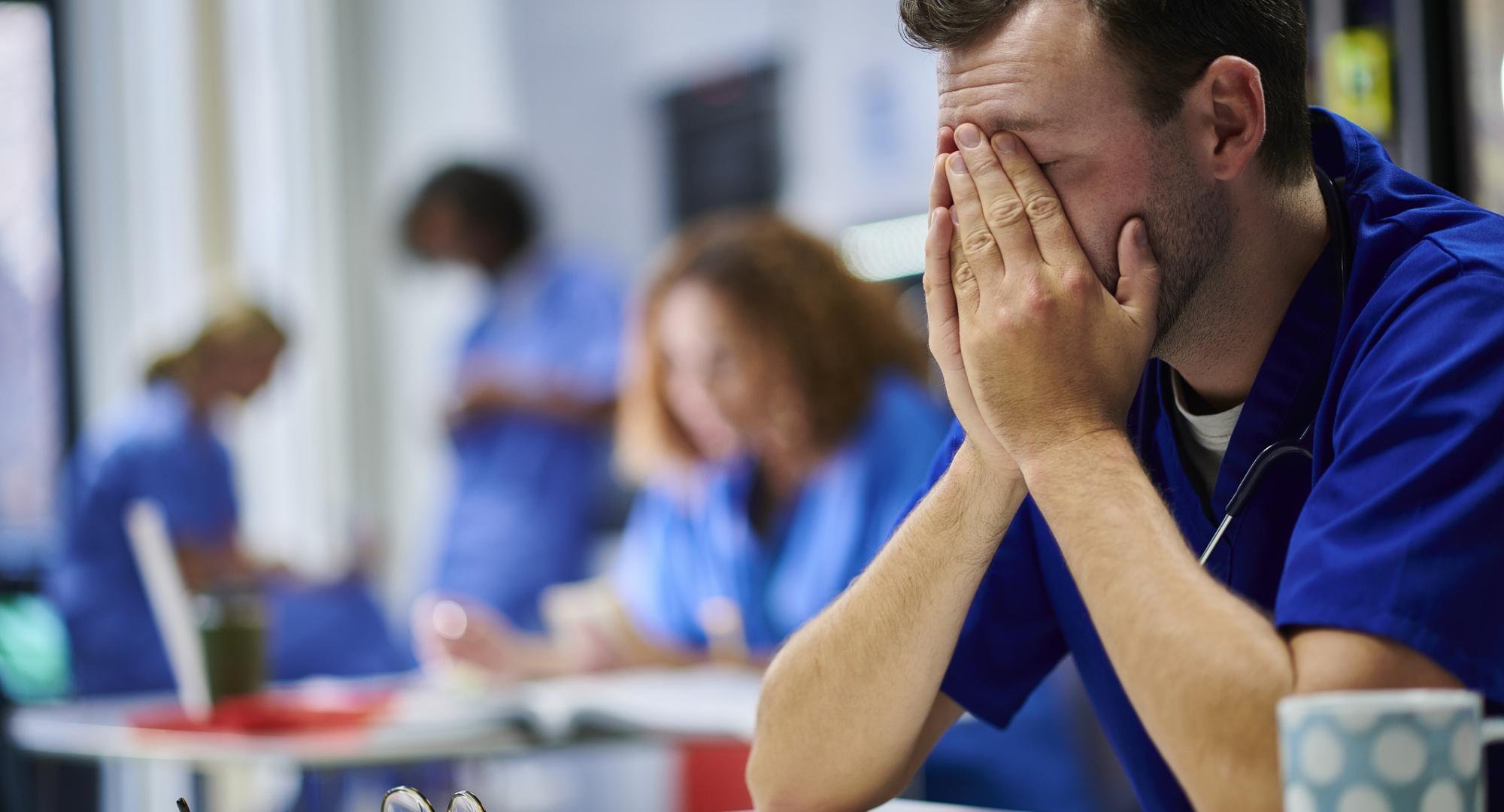 Doctor with his head in his hands