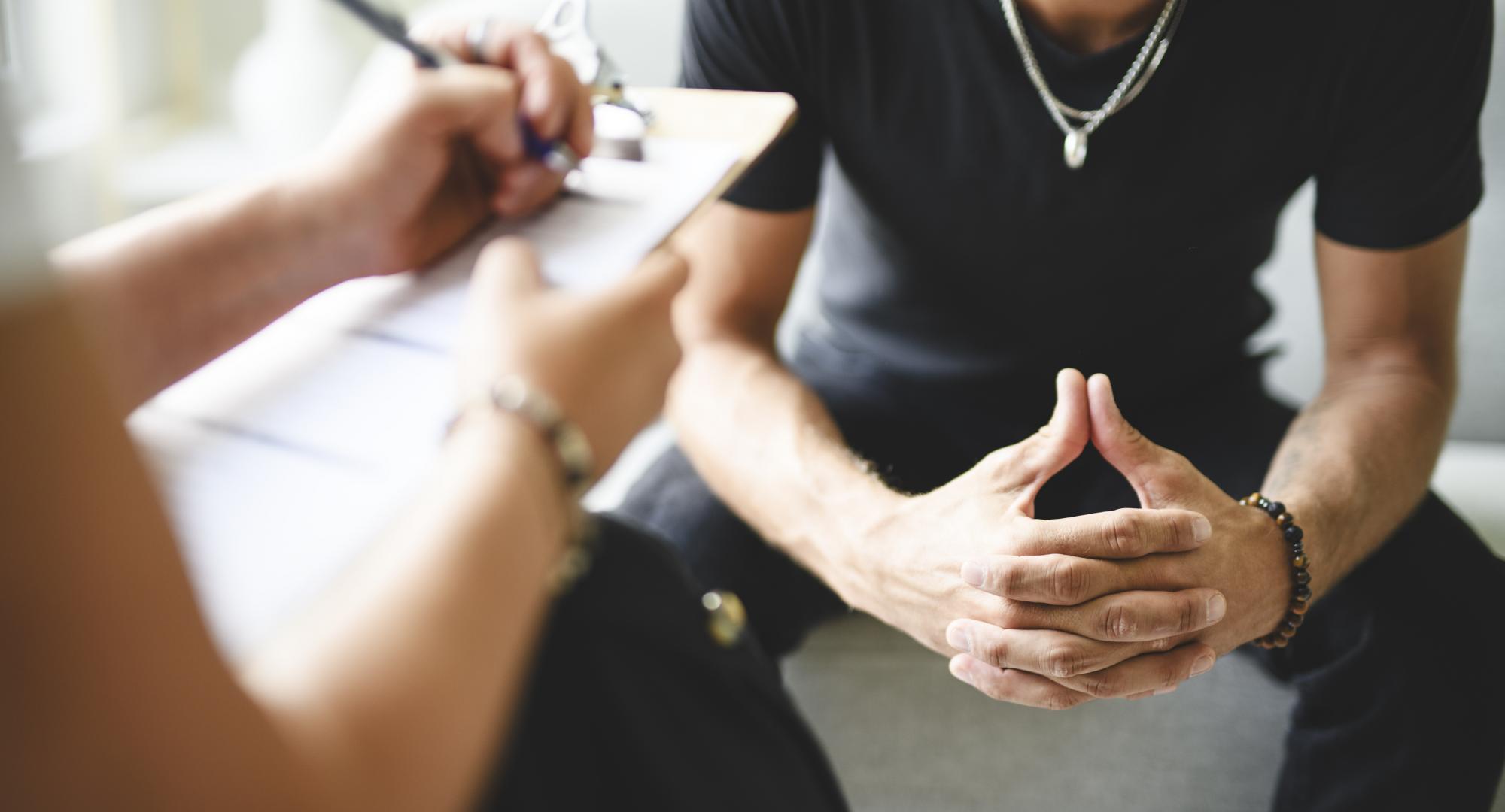 Man being supported with addiction