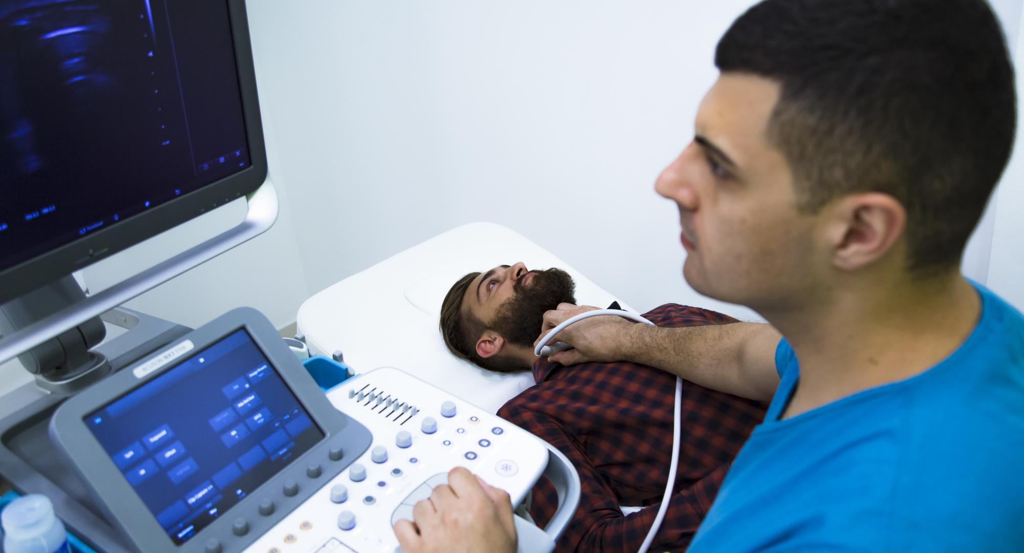 Man having his thyroid scanned