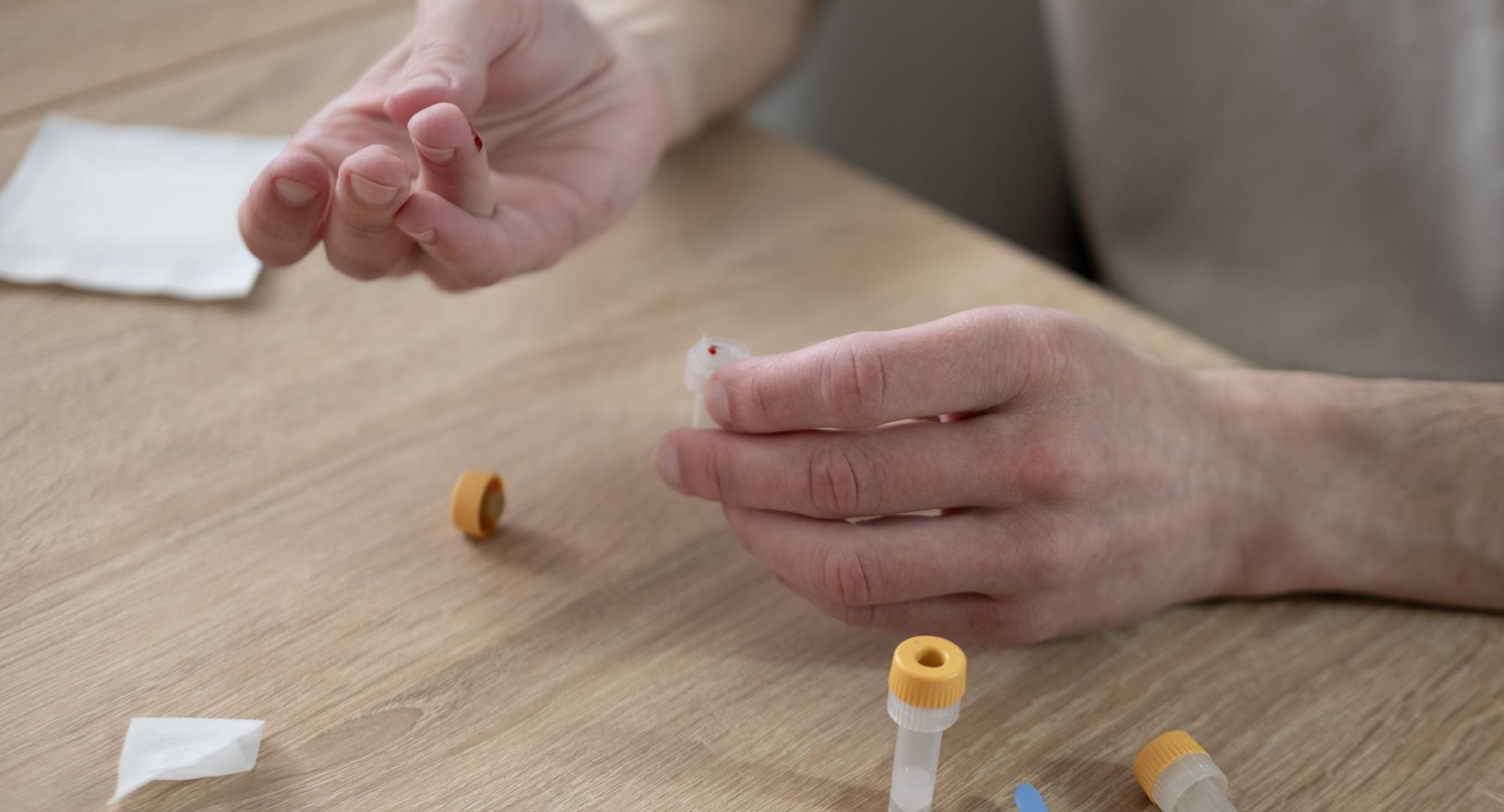 Man undertaking a finger-prick blood test