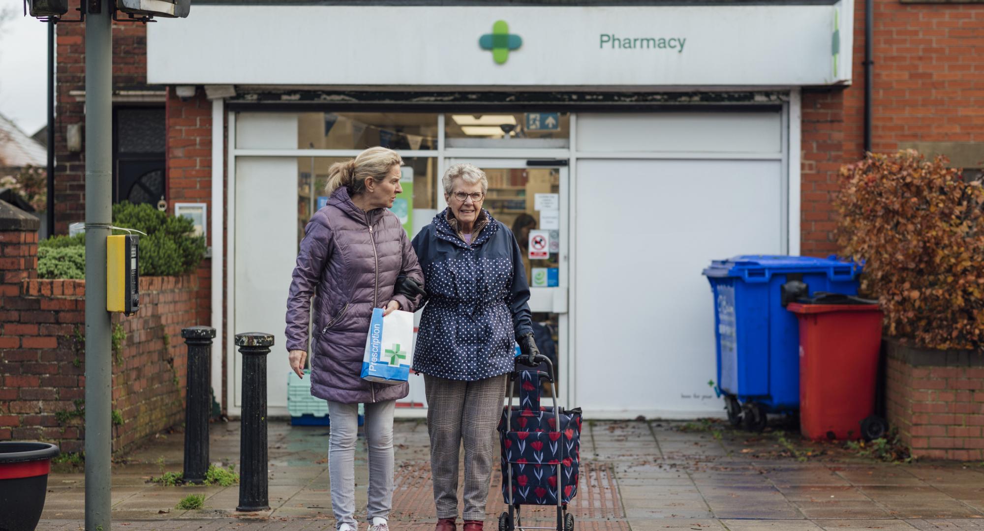 People outside a pharmacy