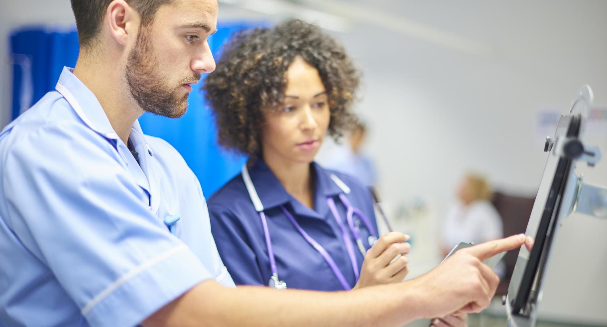 NHS staff using a tablet