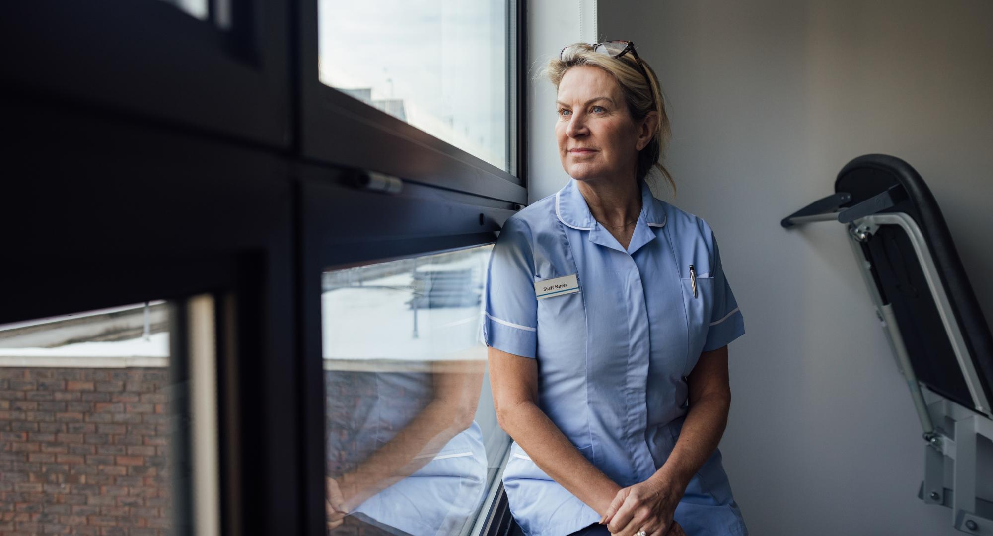 Nurse looking out of a window