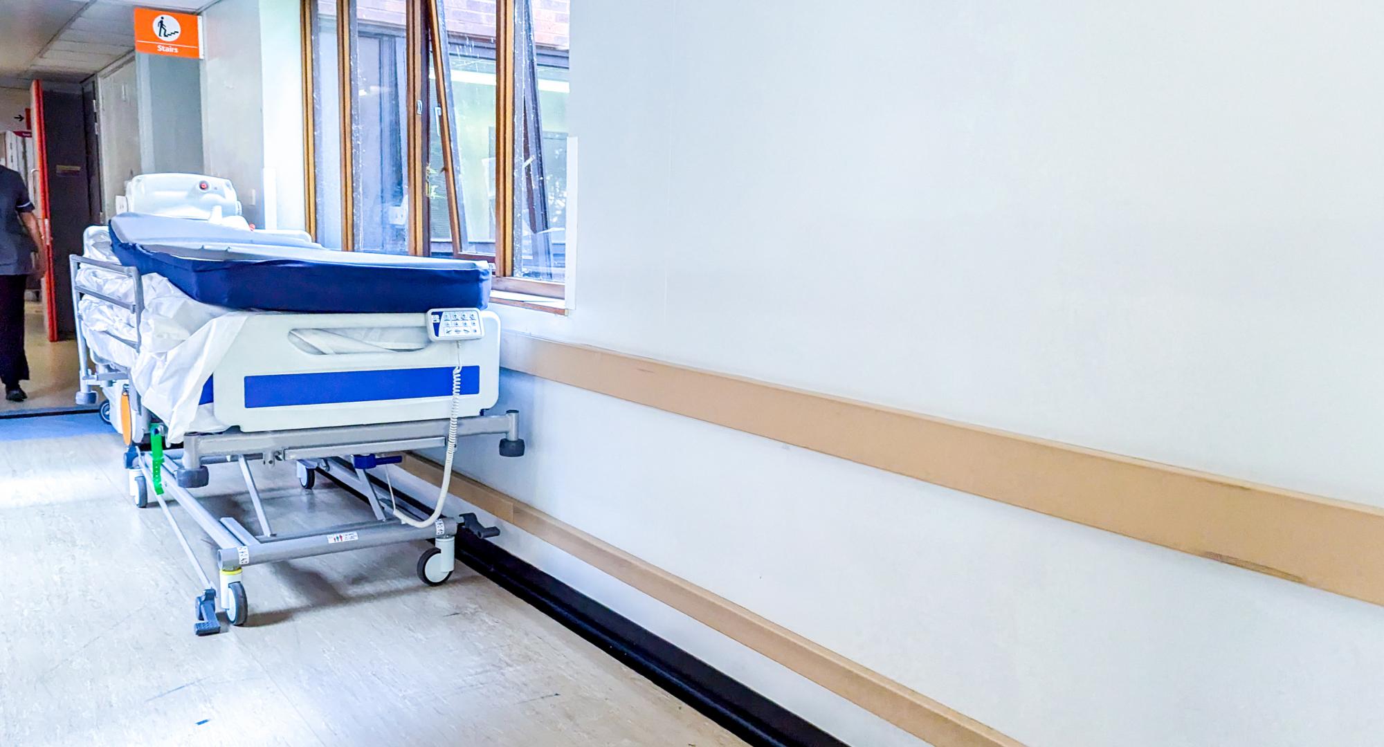 Bed in hospital corridor
