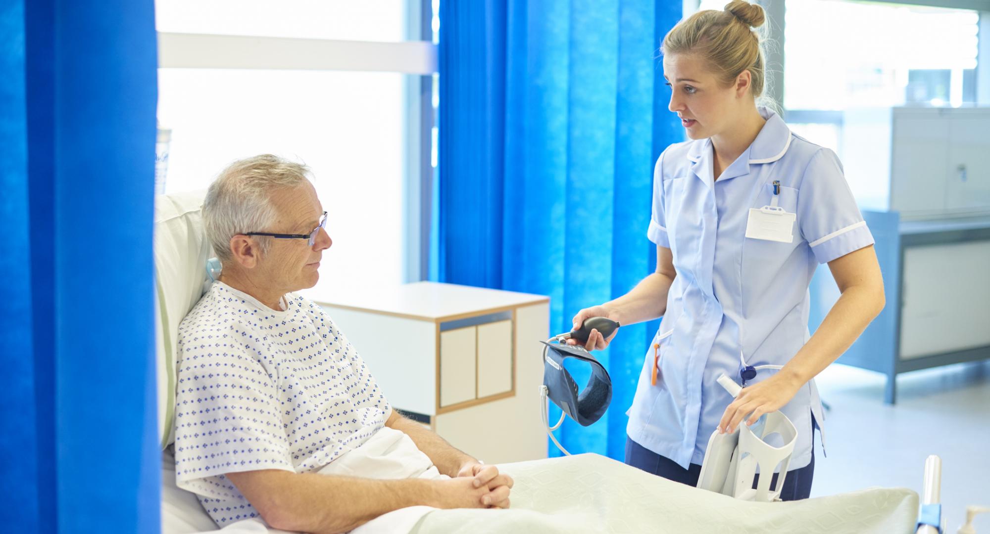 Nurse talking to a older male patient