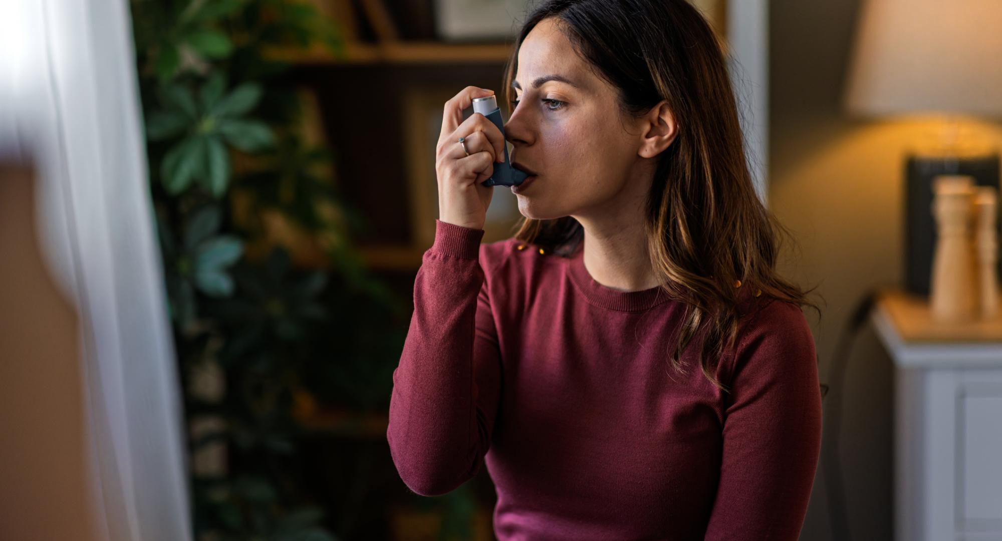 Woman using an inhaler