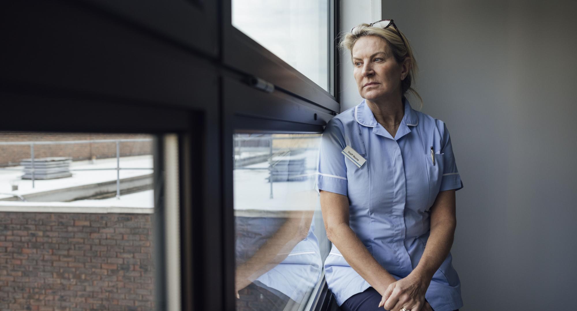 Nurse sat by a window