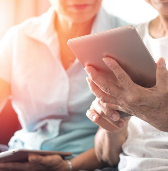 Two people using a tablet PC