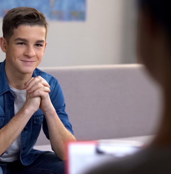 Young man on sofa discussing