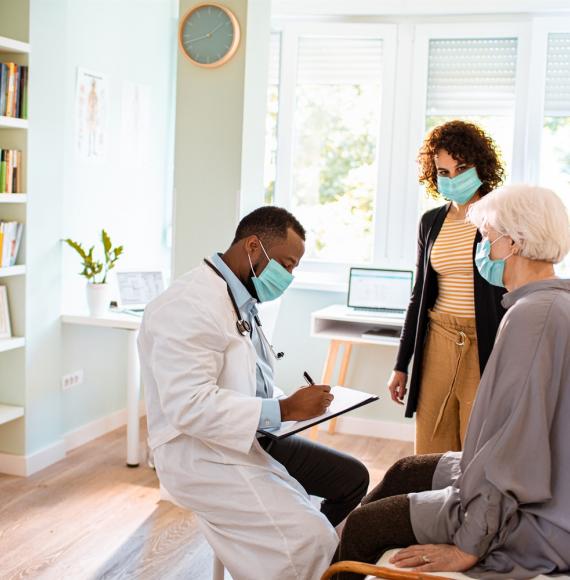 Male doctor discussing with two patients