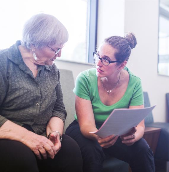 Woman supporting elderly patient